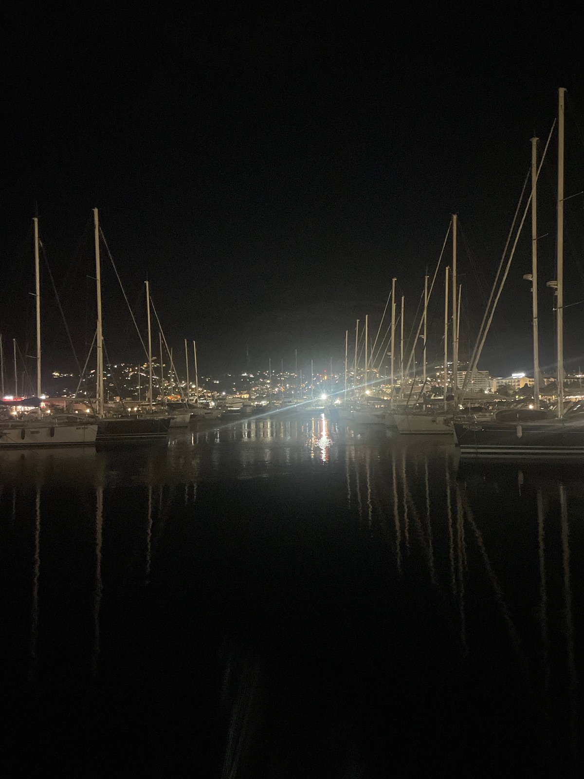 Bar Marina at night, boats moored under city lights