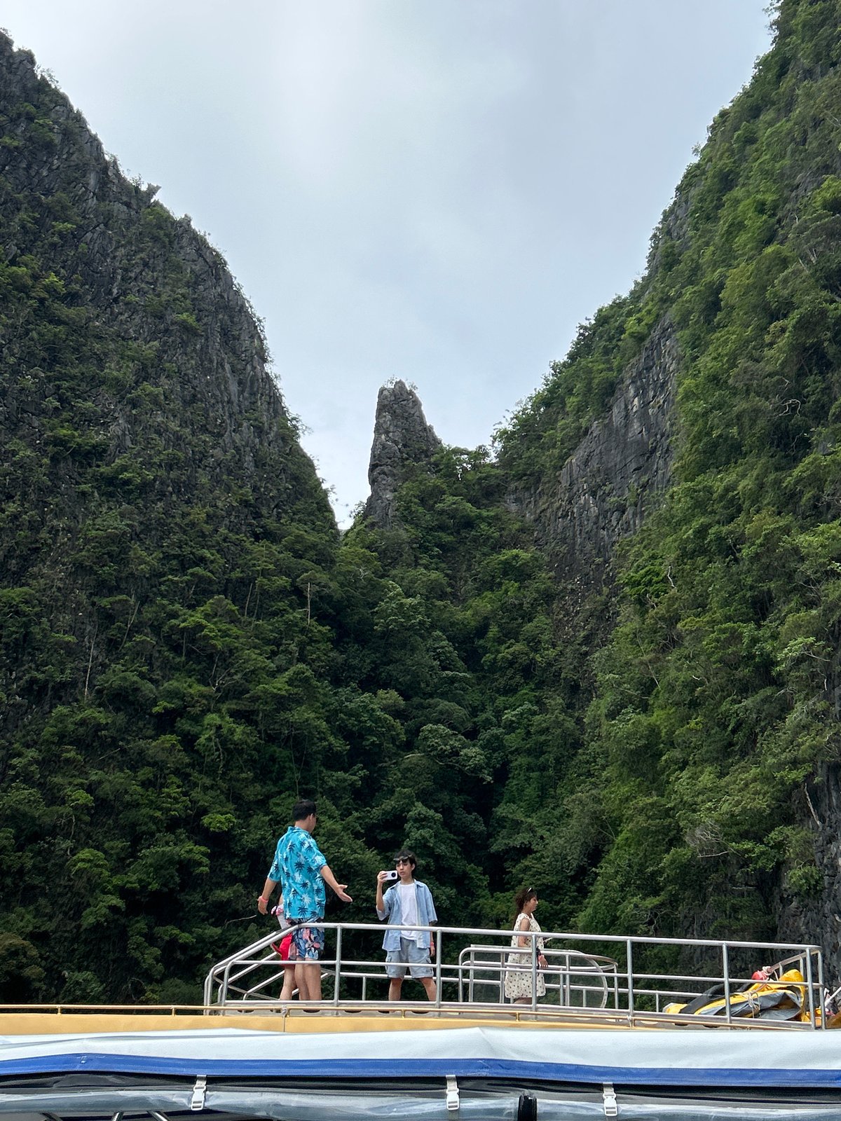 Boat navigating between limestone cliffs in Ao Nang