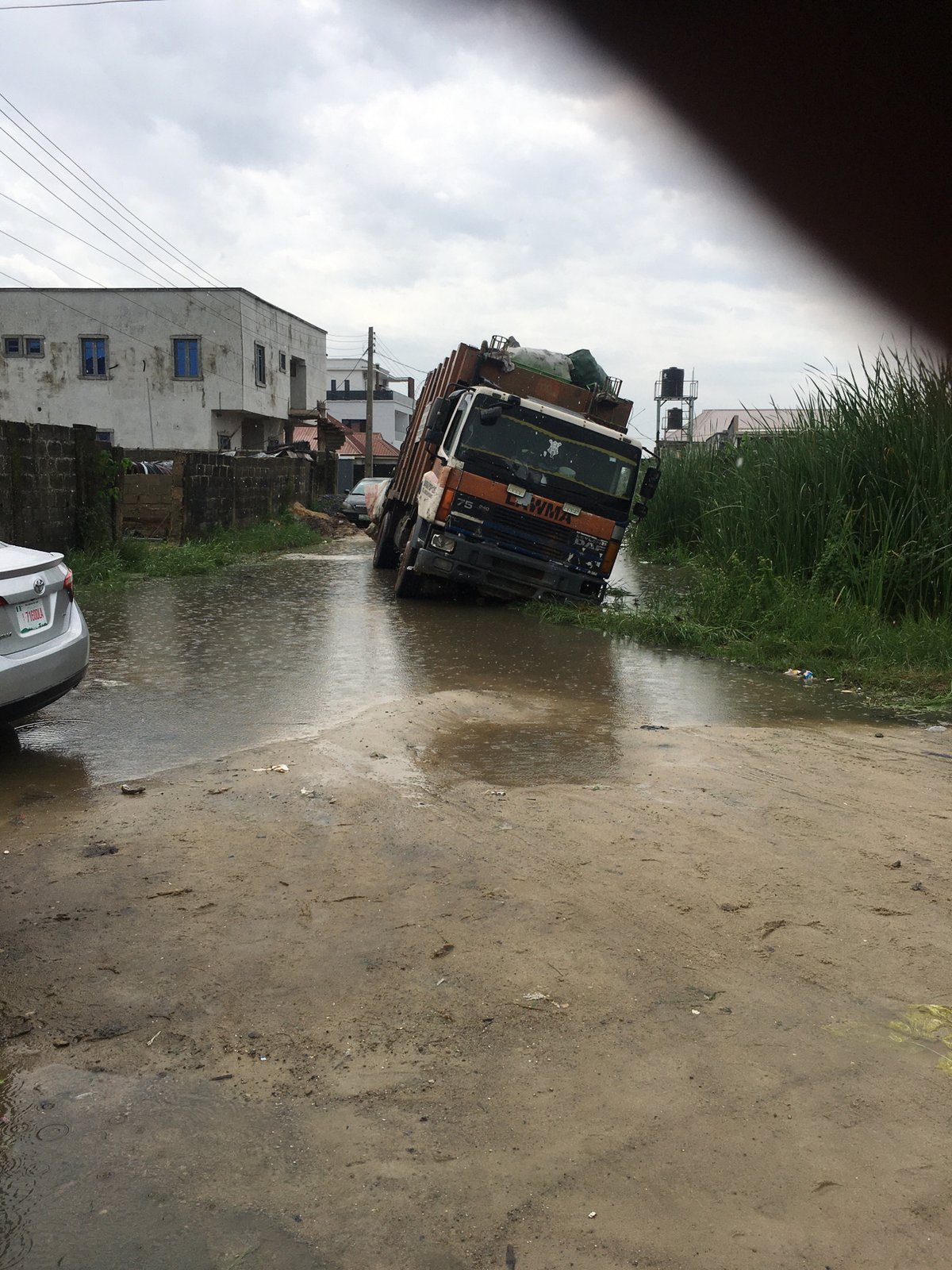 Utility truck tilts, submerges in Ado Nigeria floodwaters
