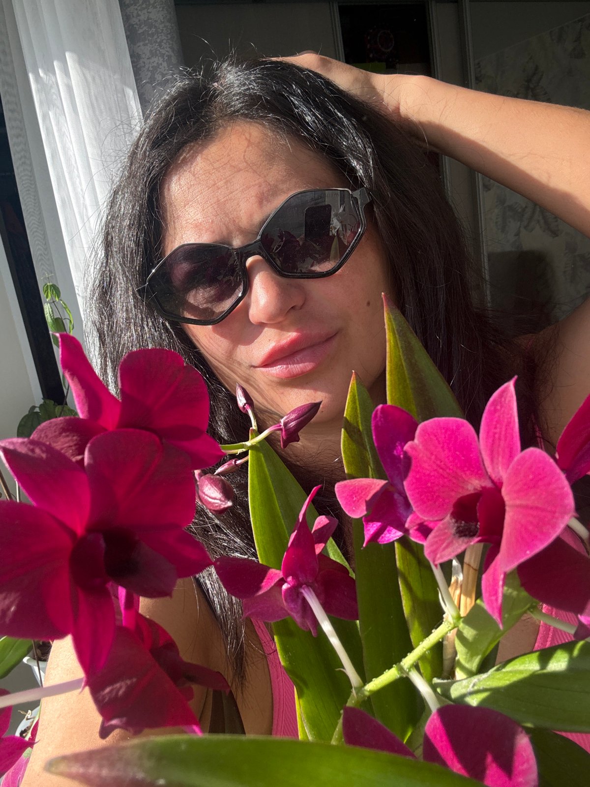 Woman photographed with orchids in Russian flower arrangement session