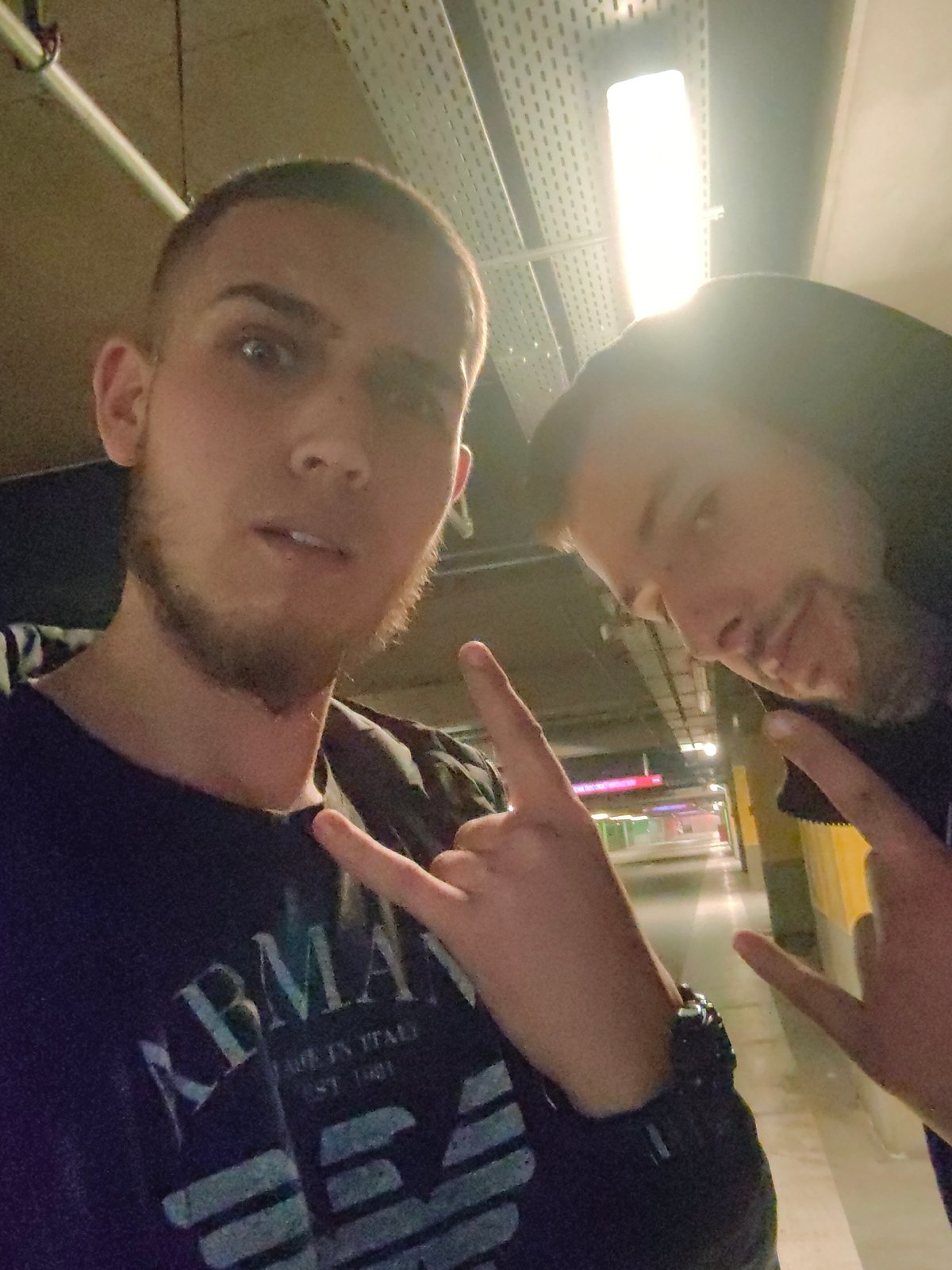 Two men photographed in Sofia parking garage