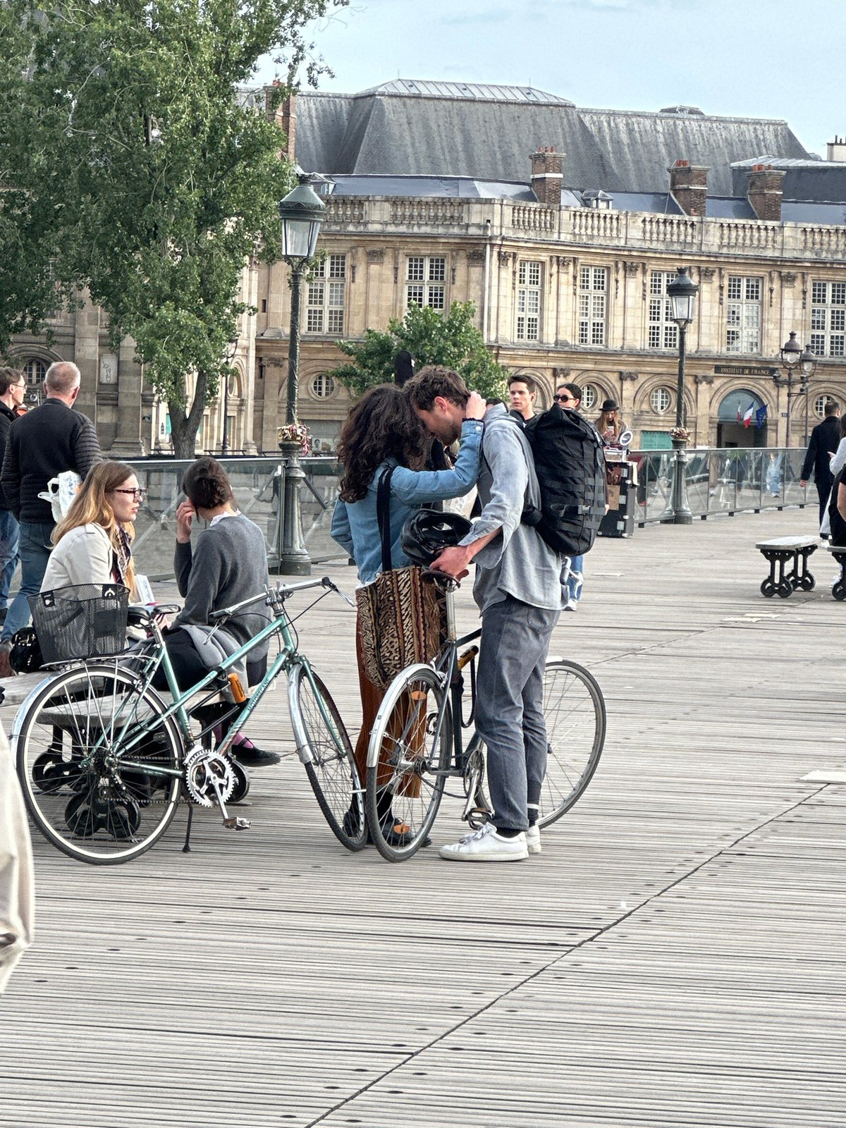 Parisians and tourists enjoy typical evening activities along Seine River