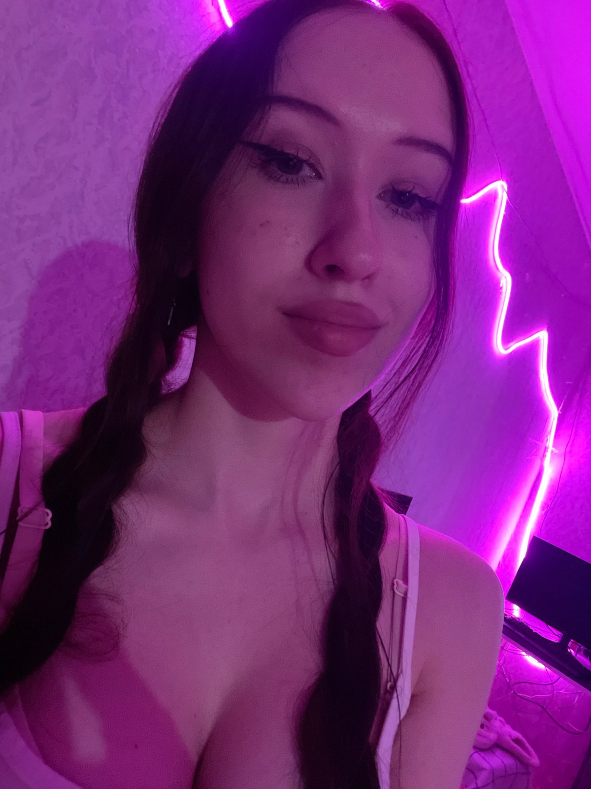 Woman takes selfies in purple-lit room in Votkinsk, Russia