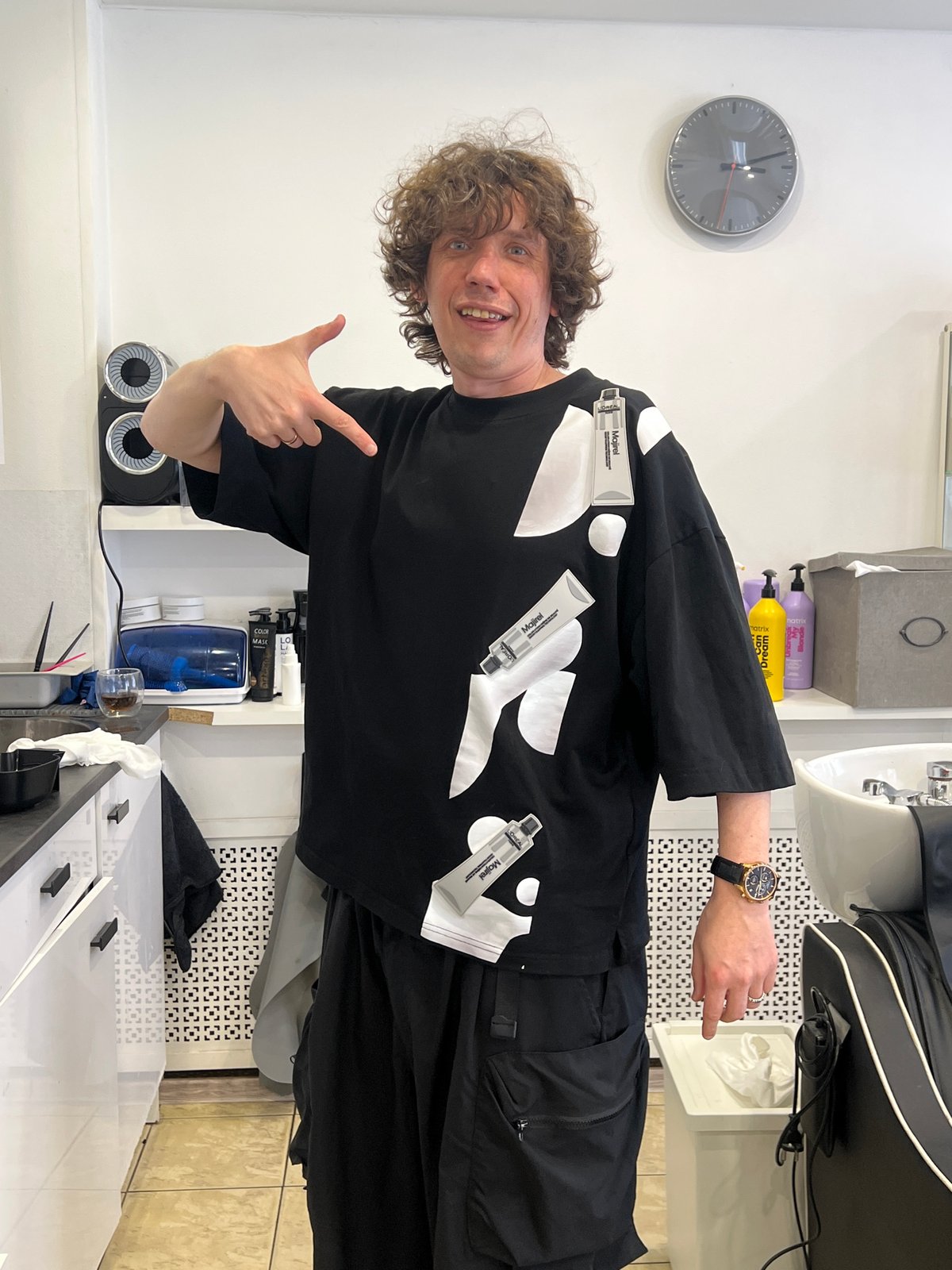 Man displays hair color products on shirt in Saint Petersburg