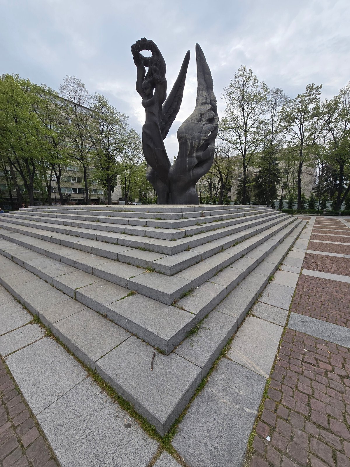 Bronze monuments and Cyrillic signage documented in urban setting