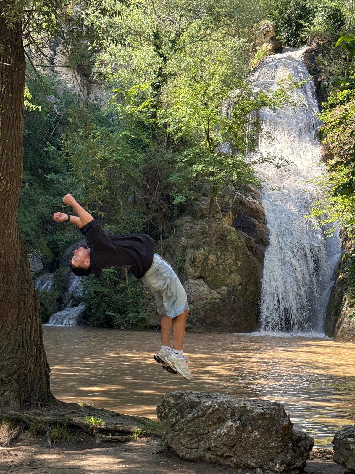 Man performs backflip stunt at Hotnitsa Waterfall, Bulgaria