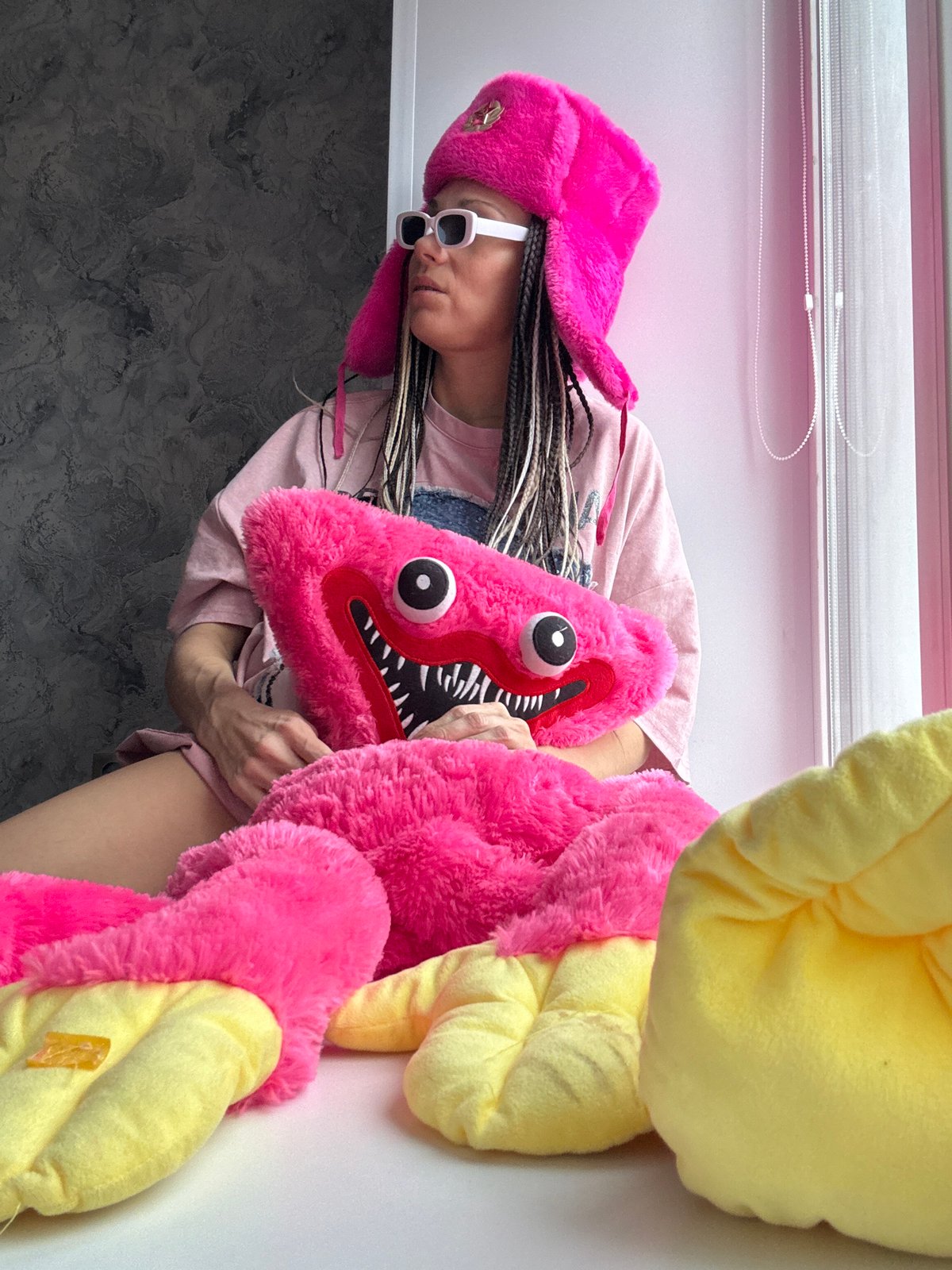 Person displays colorful plush toys in Rusanovo, Russia