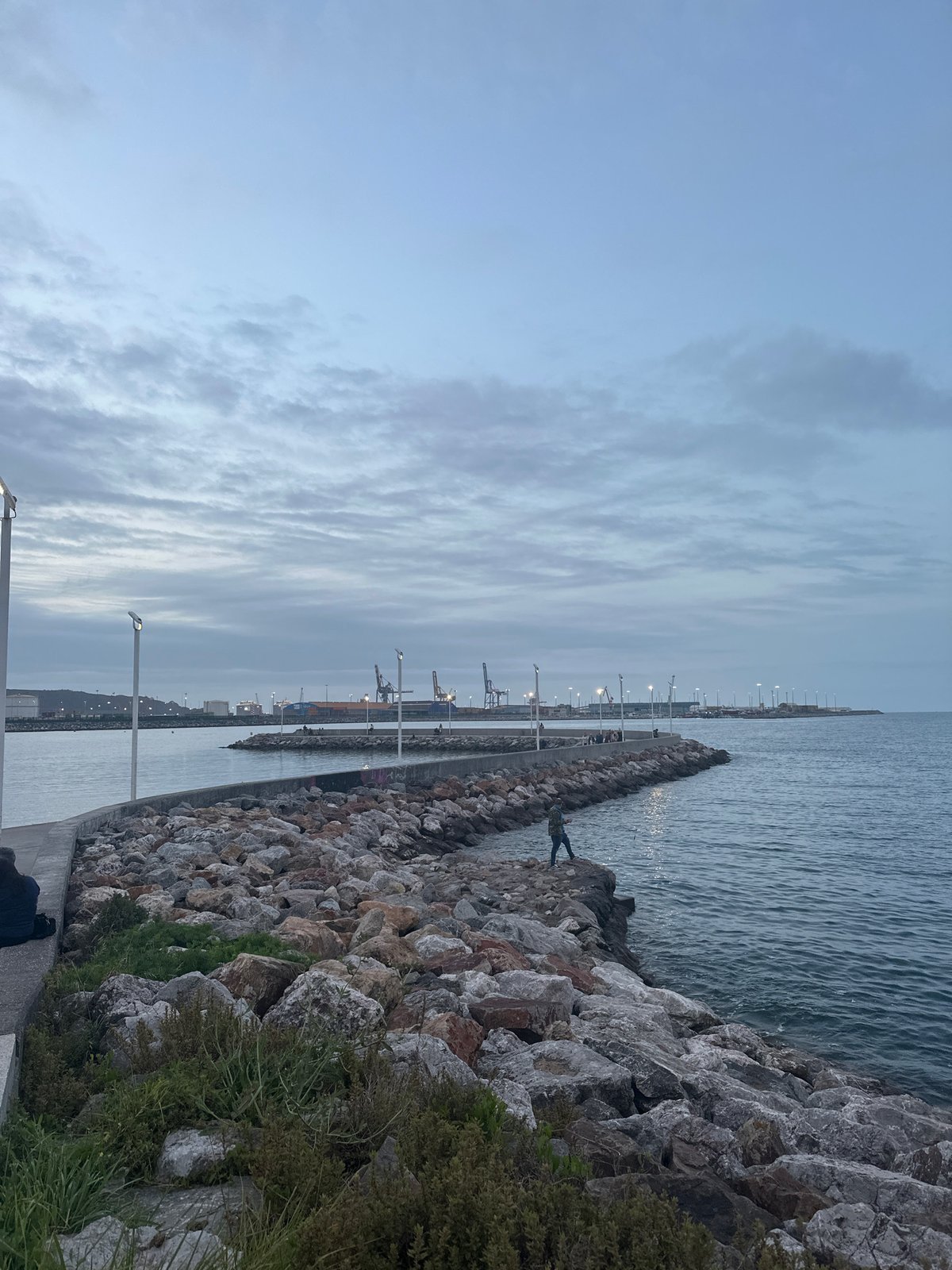 Twilight observed over Gijón industrial port coastline