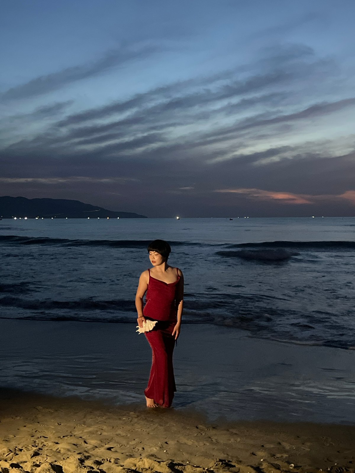 Dusk on a Đà Nẵng beach, red dress and fading light