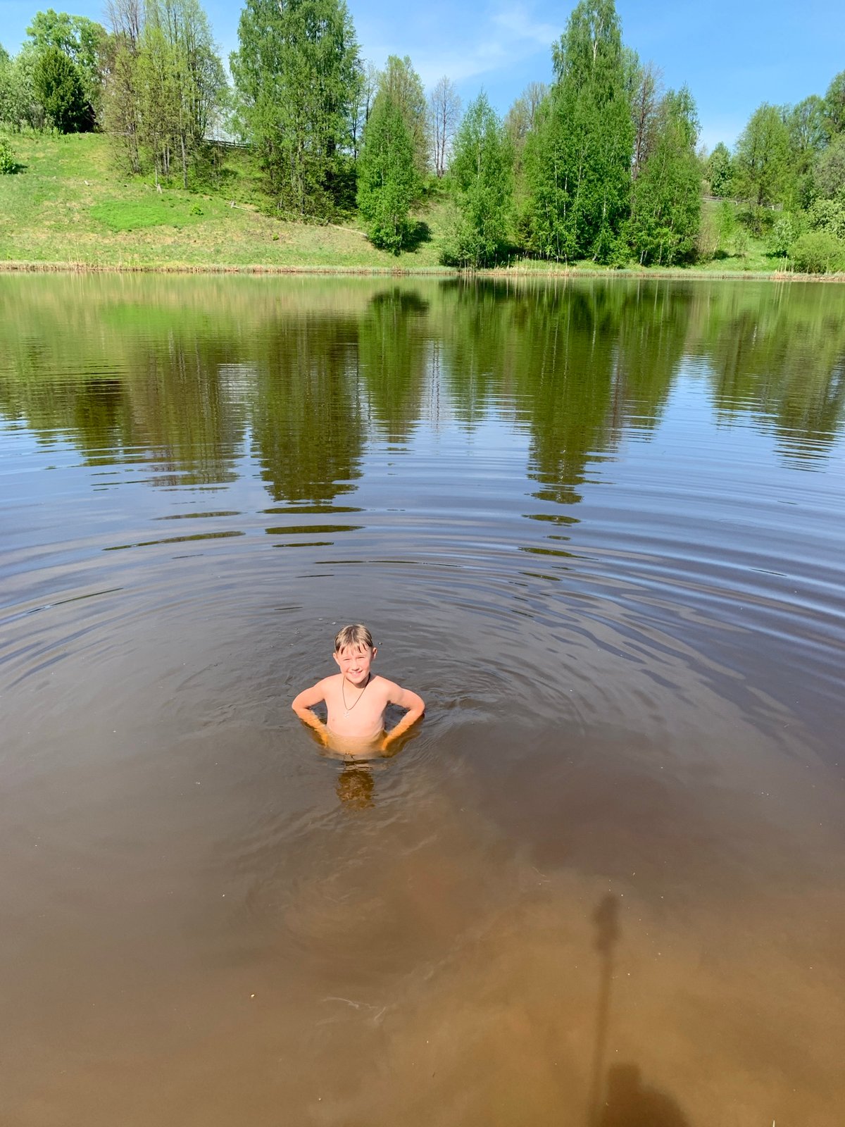 Swimmers enjoy murky waters in Zasechnyi, Russia