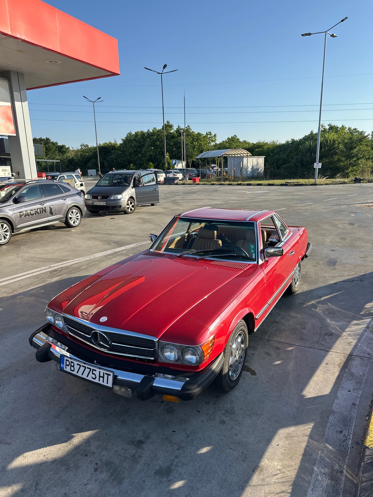 Classic Mercedes and three-wheeled motorcycle meet at Bulgarian gas station