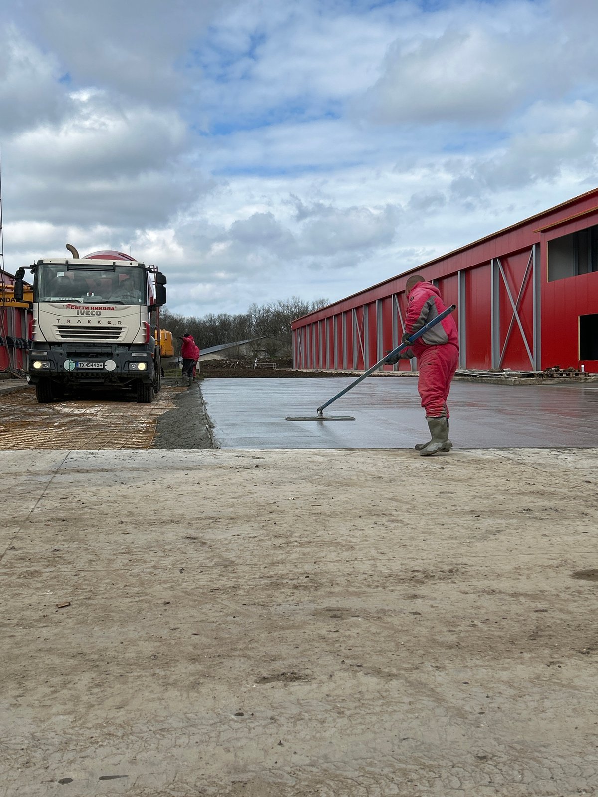 Construction worker smooths concrete slab in Donchevo, Bulgaria