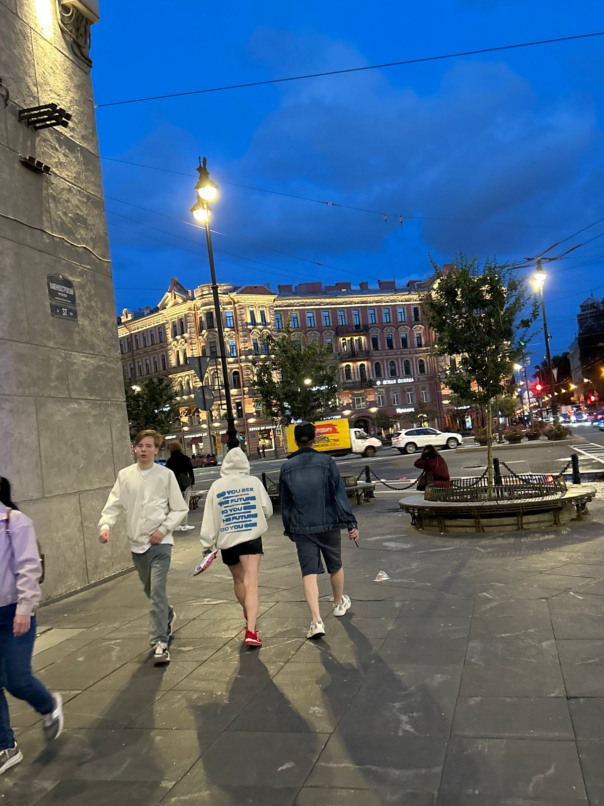 Ornate city streets come alive under a deep dusk sky