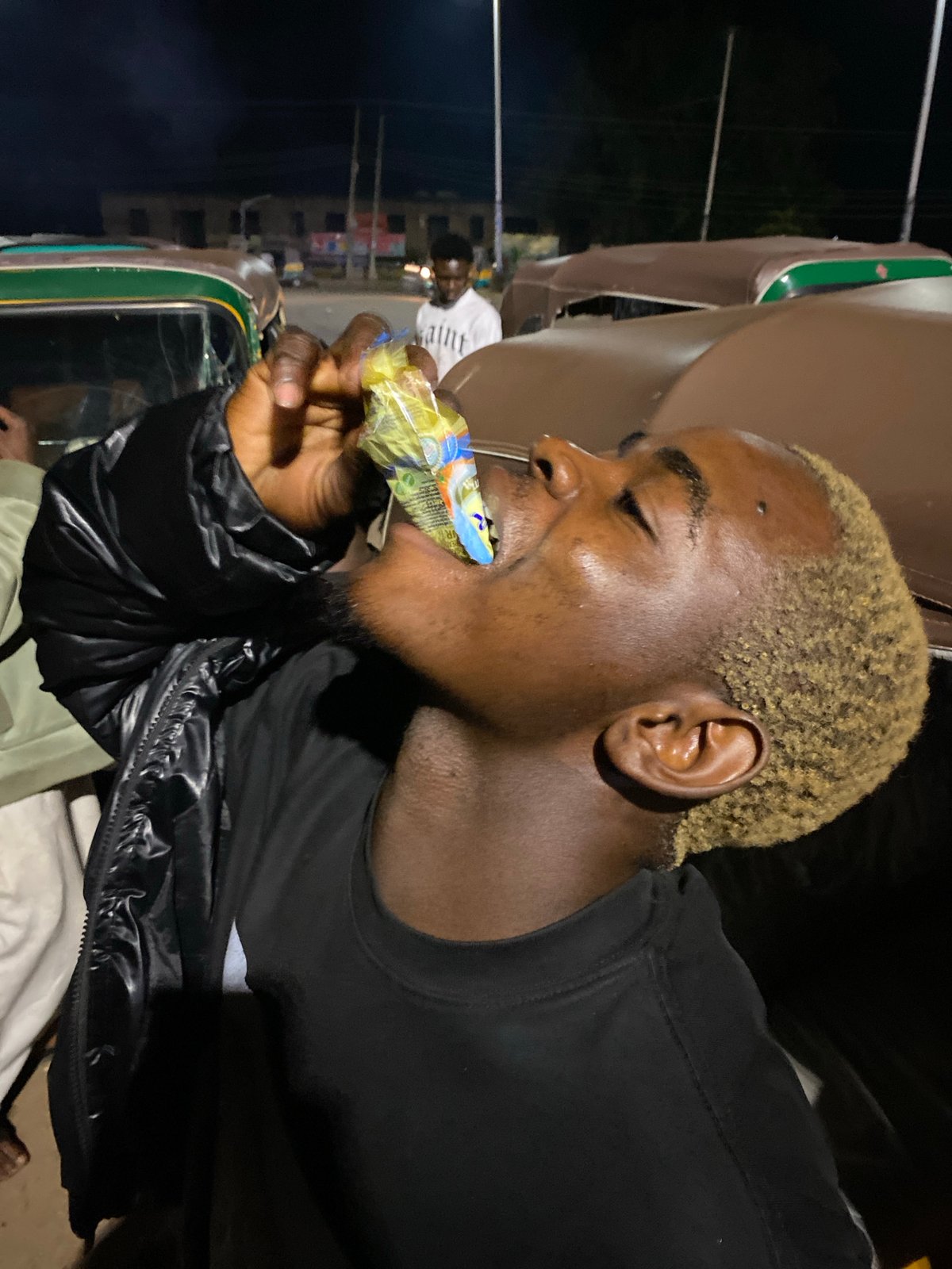 Bukuru streets at night: traffic, overloaded vehicles, roadside life