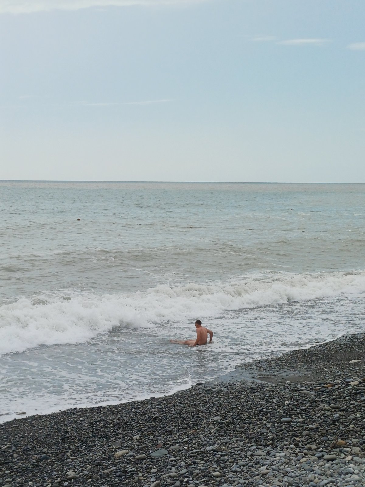 Quiet day on Sochi's pebble beach under overcast skies
