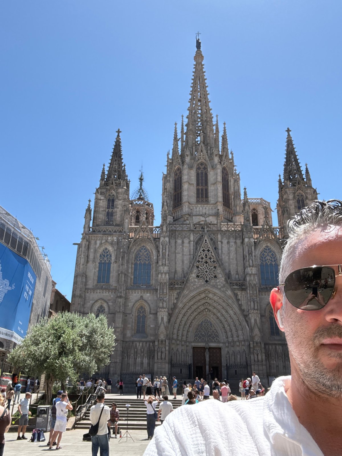 Tourist photographs Barcelona Cathedral on sunny morning