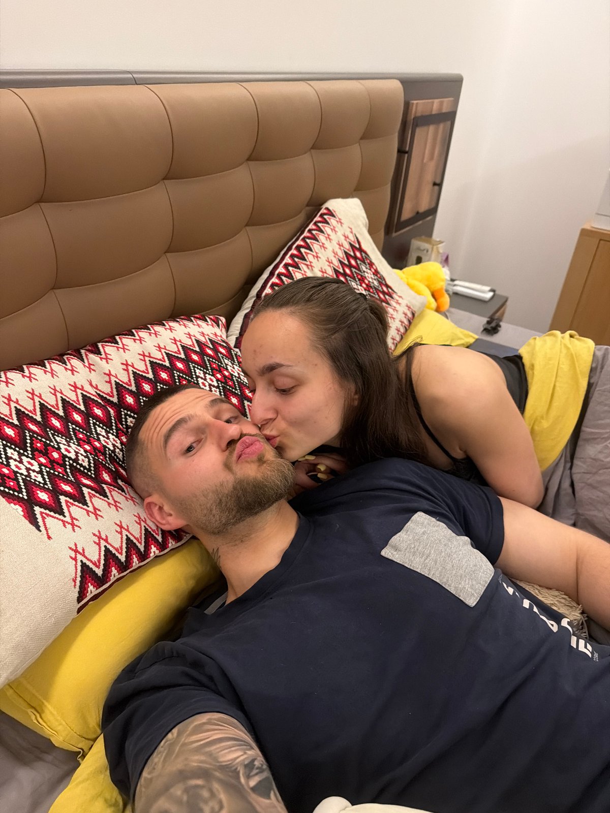Intimate moment captured between couple in Sofia bedroom