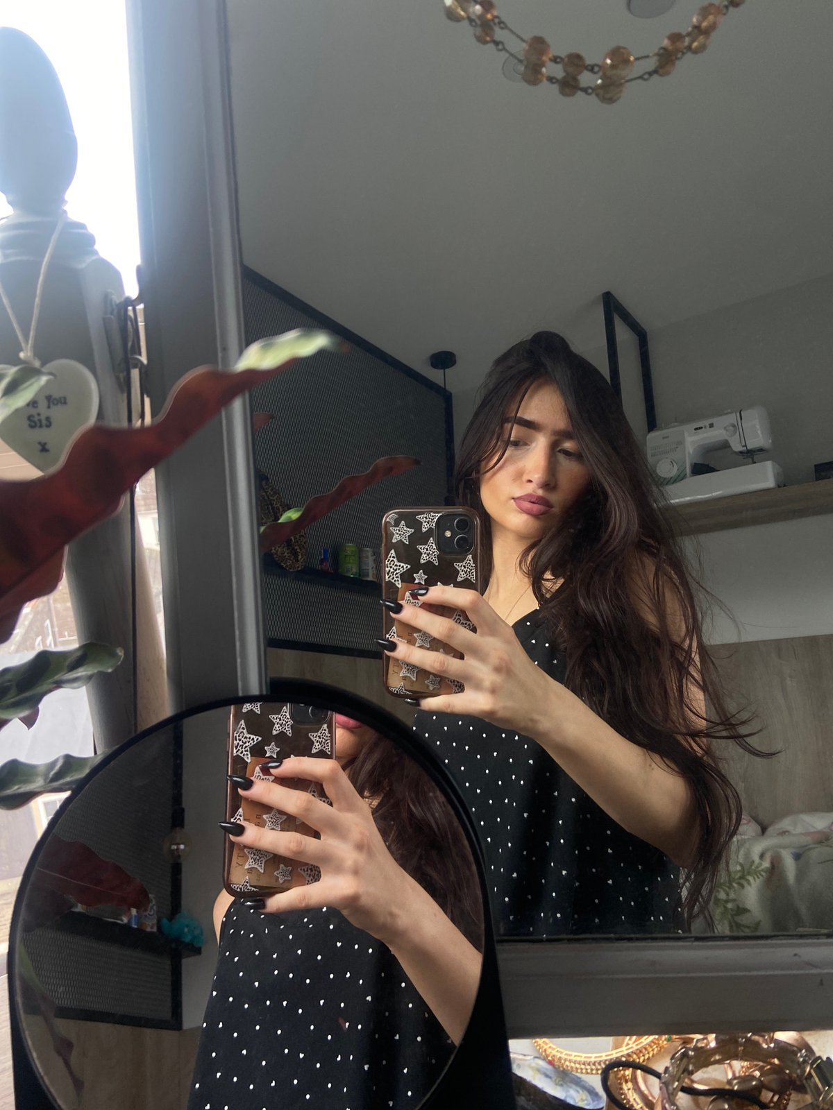 Young woman takes morning mirror selfies in London residence