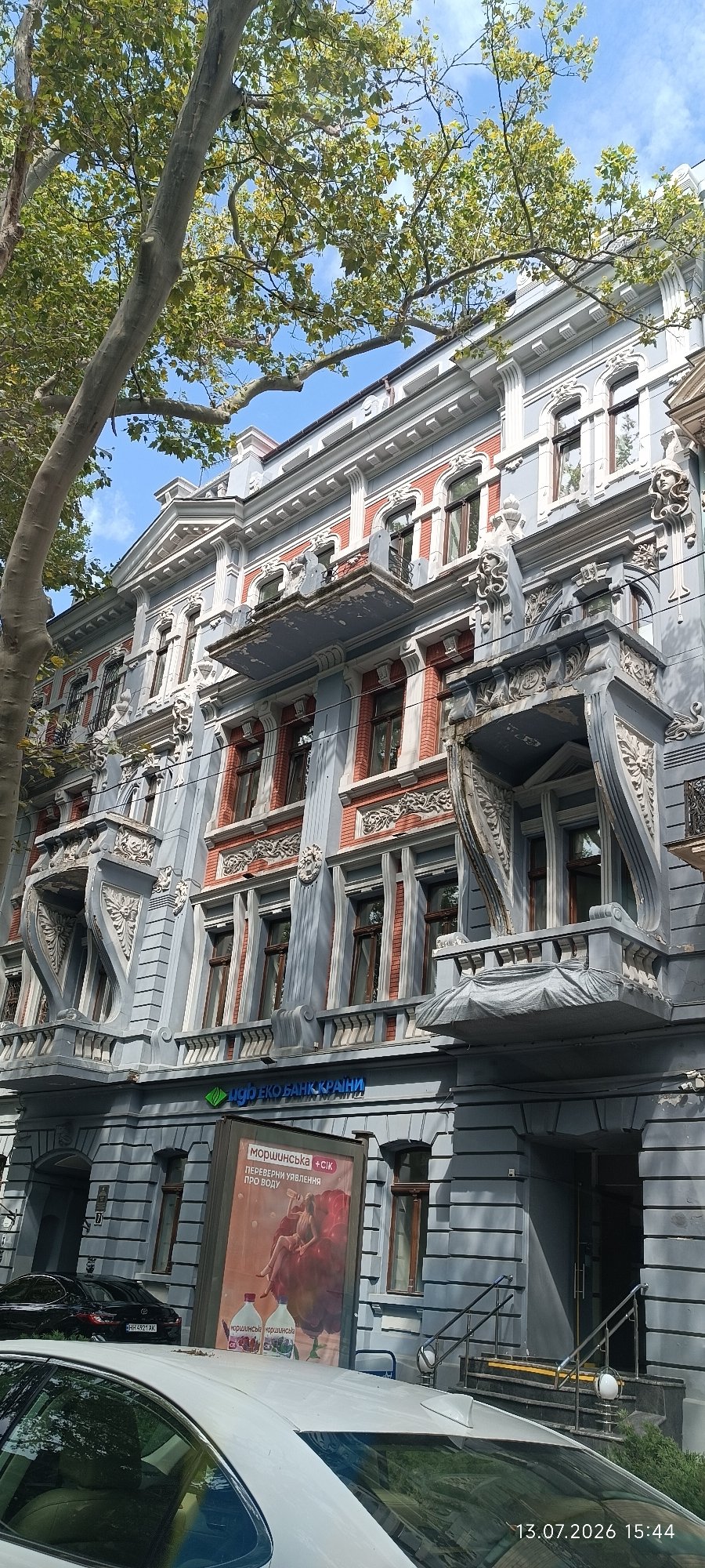 Ornate light blue building with decorative balconies in Odesa