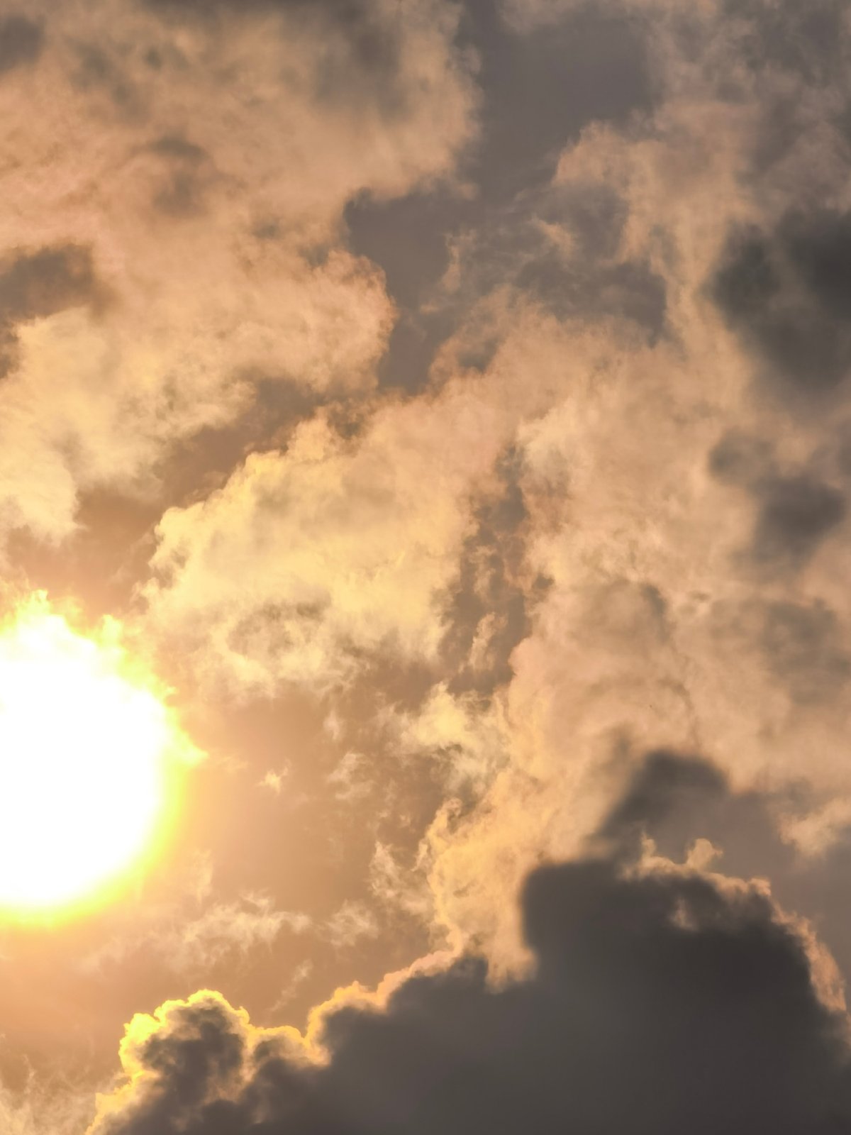 Sunlight breaks through dramatic cloud cover in layered sky shots
