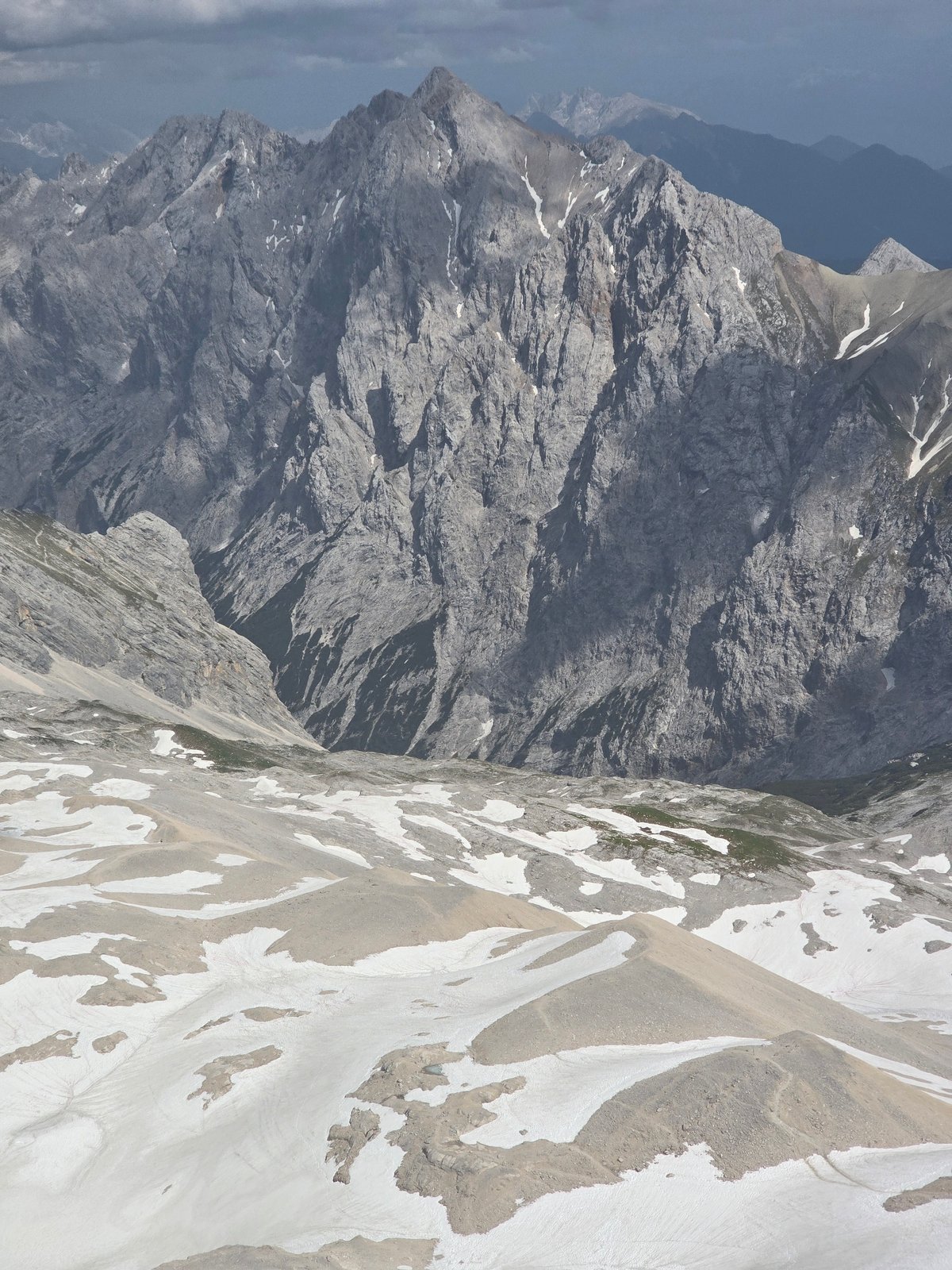 Aerial views over the rocky, snow-dusted Zugspitze range