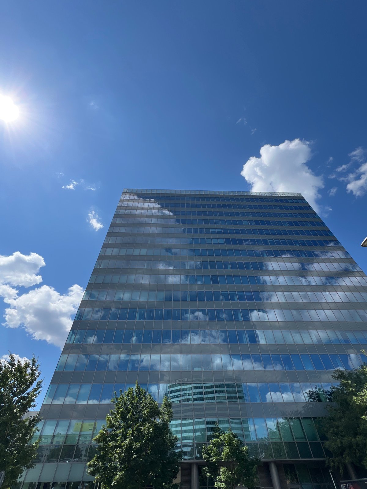 Glass skyscraper reaches into a clear Budapest sky