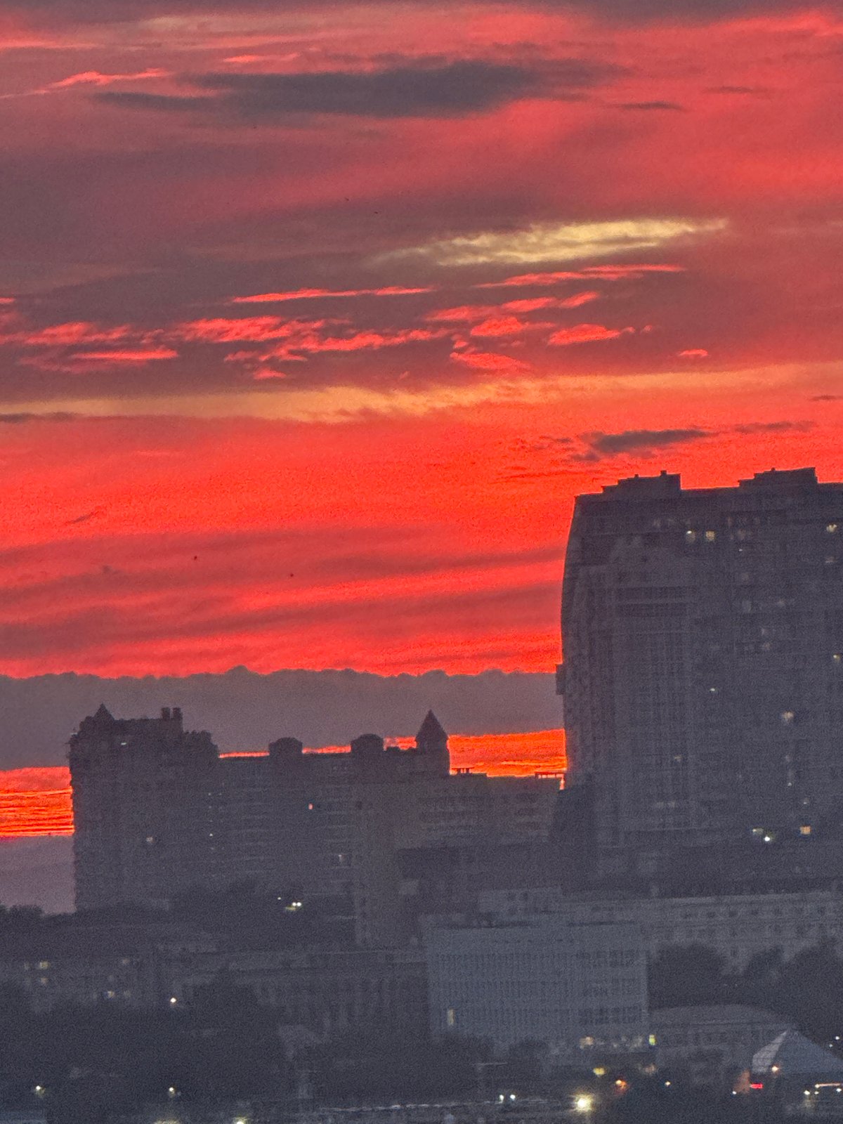 Vladivostok harbor glows red at sunset, port traffic rolling