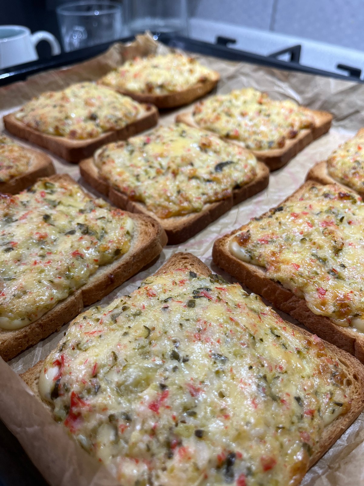 Cheesy toast on a baking sheet, fresh from the oven