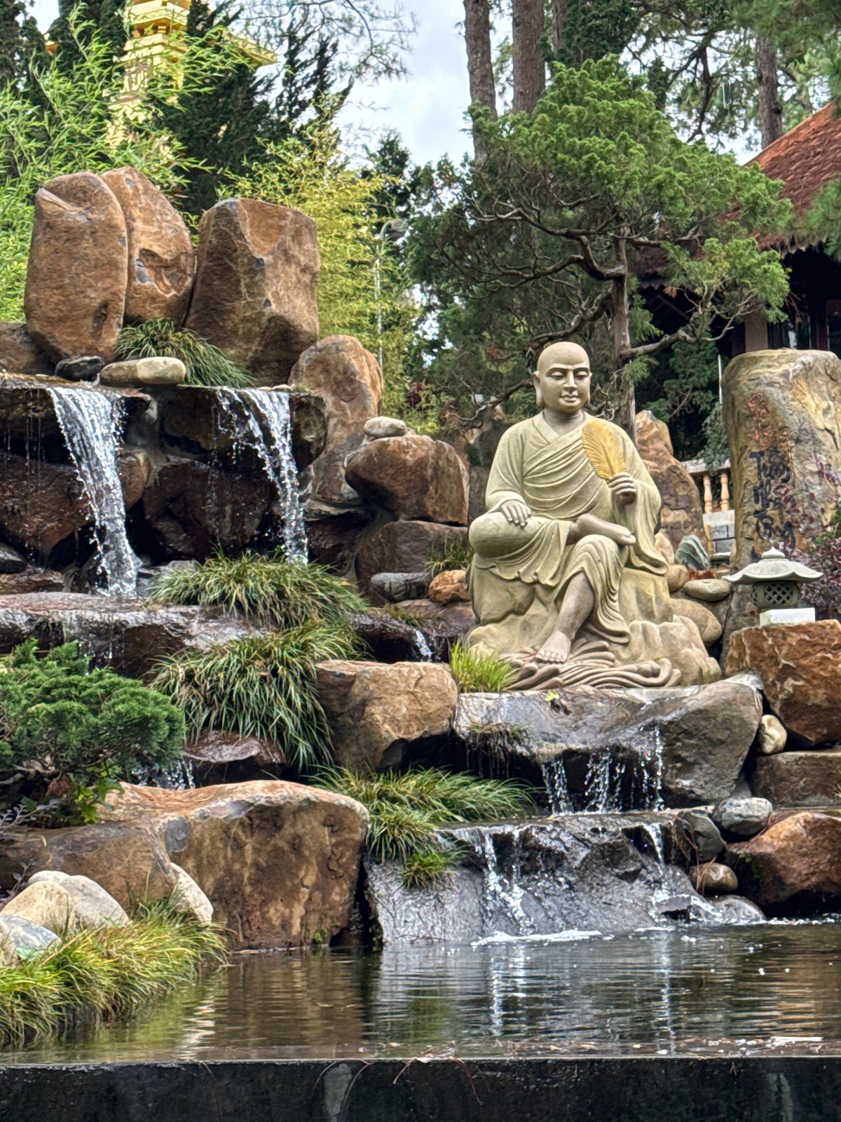 Visitors explore Buddhist monastery grounds in Da Lat, Vietnam