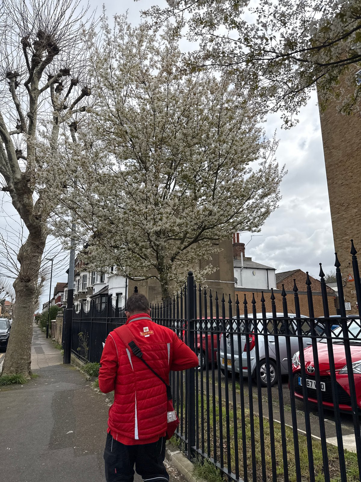 Royal Mail worker empties postbox on London street