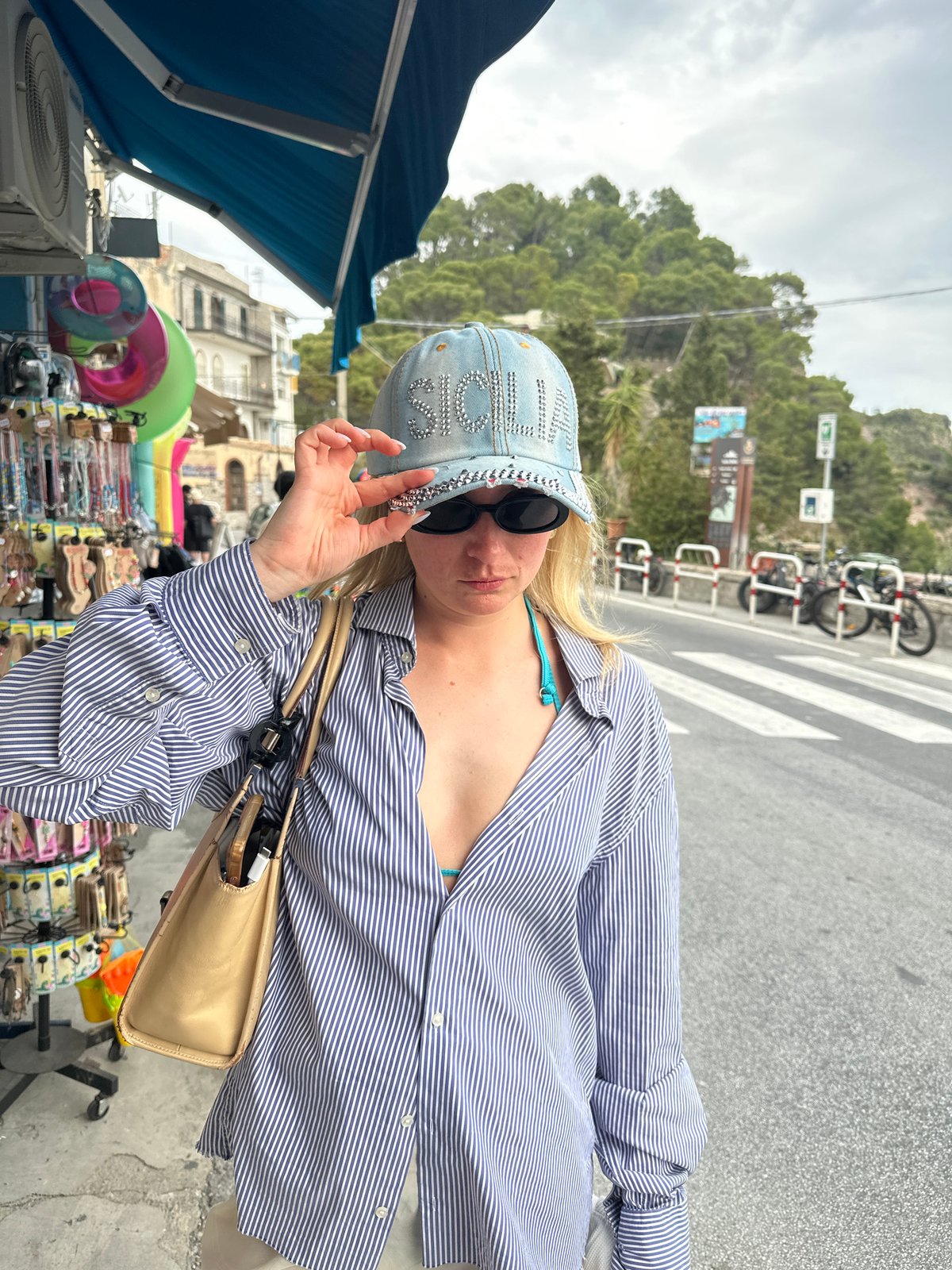 Tourist captures street scenes and coastal views in Taormina