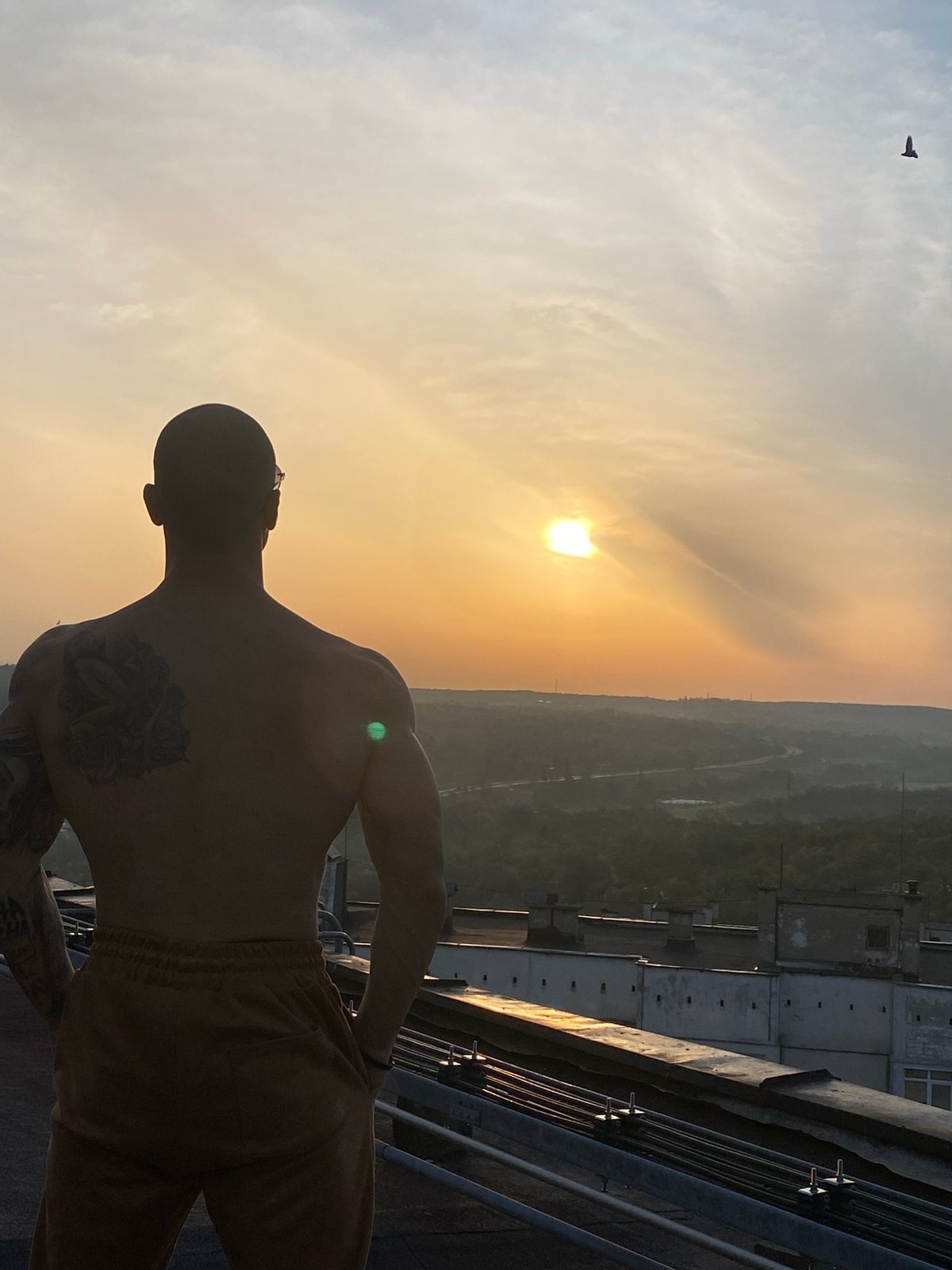 Man photographed on rooftop during sunset in Pleven, Bulgaria