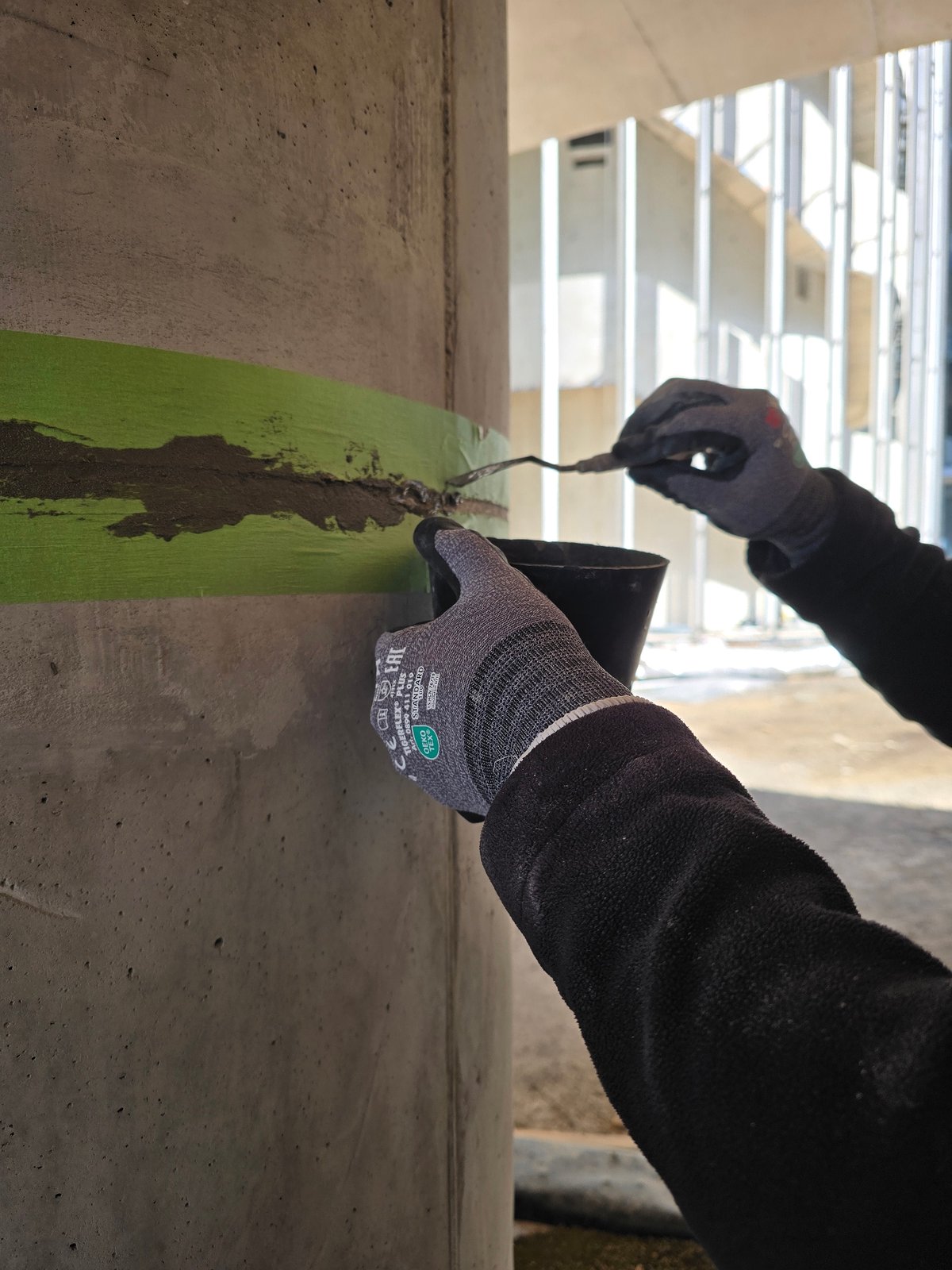 Construction workers repair concrete pillars in Ramat HaSharon