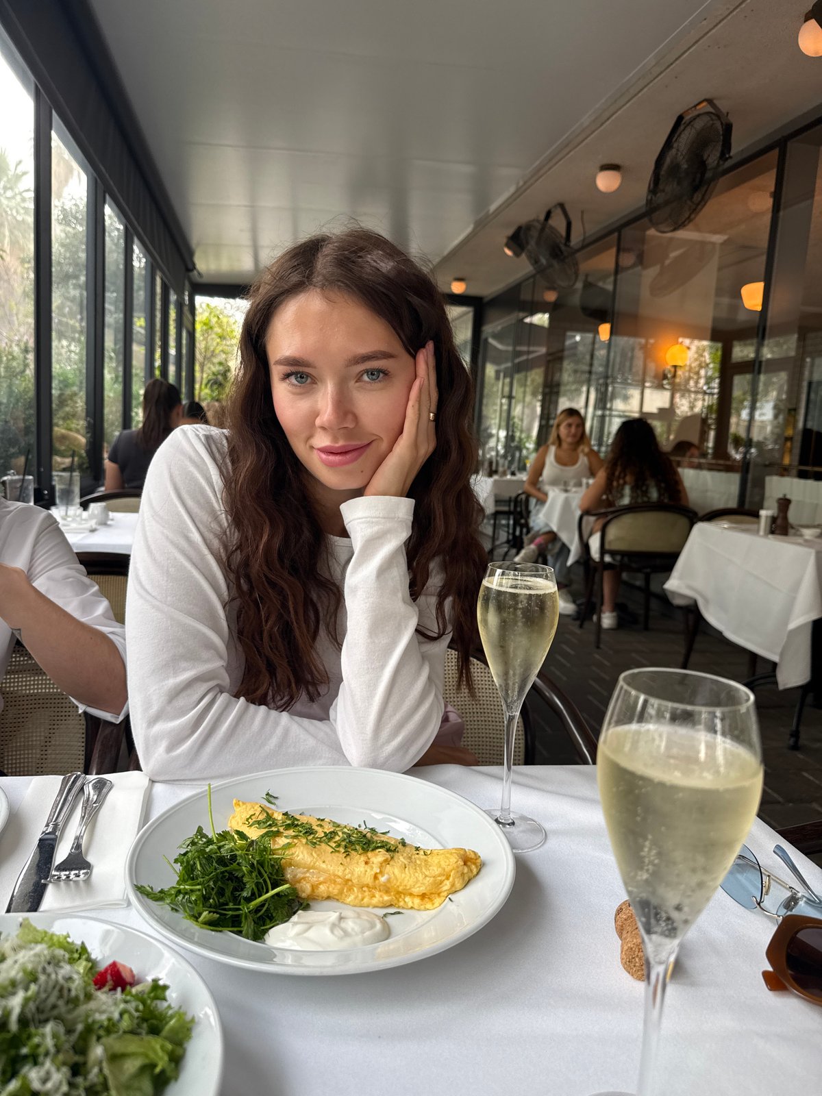 Woman enjoys champagne brunch at Tel-Aviv restaurant