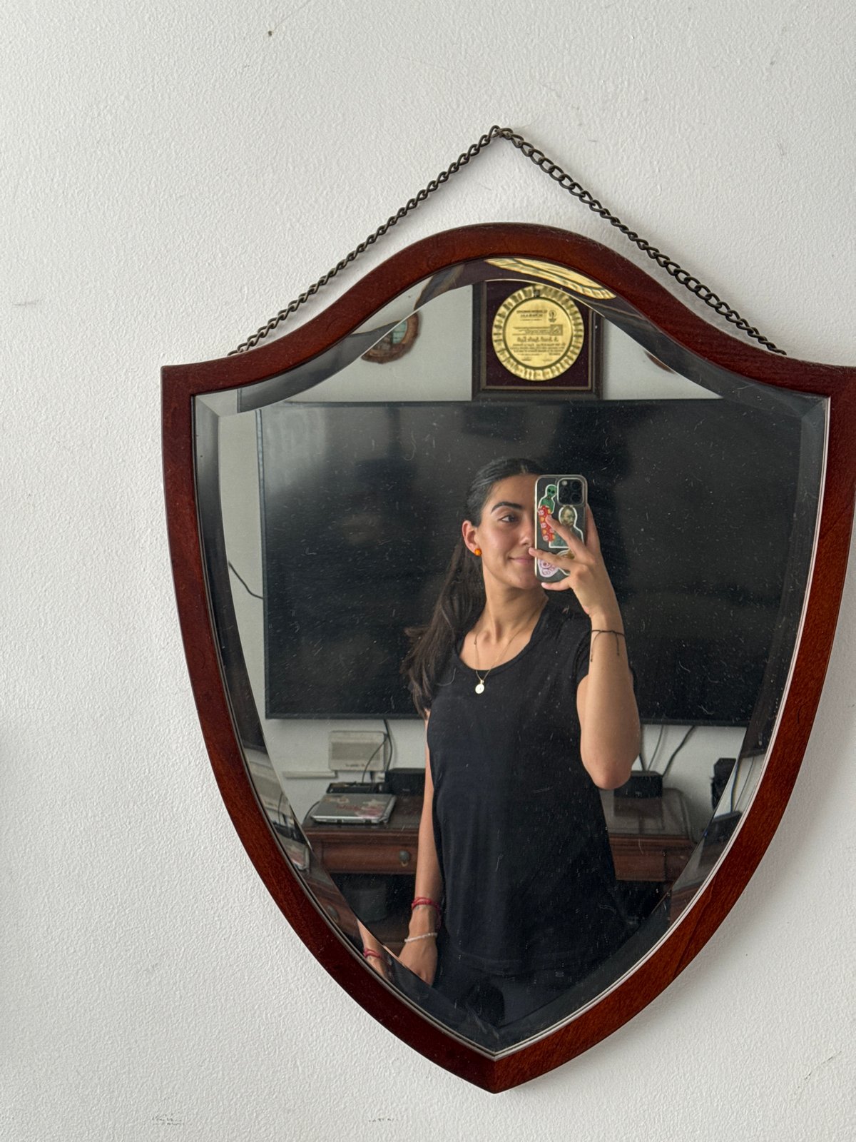 Person takes smartphone selfie in ornate mirror in Puebla