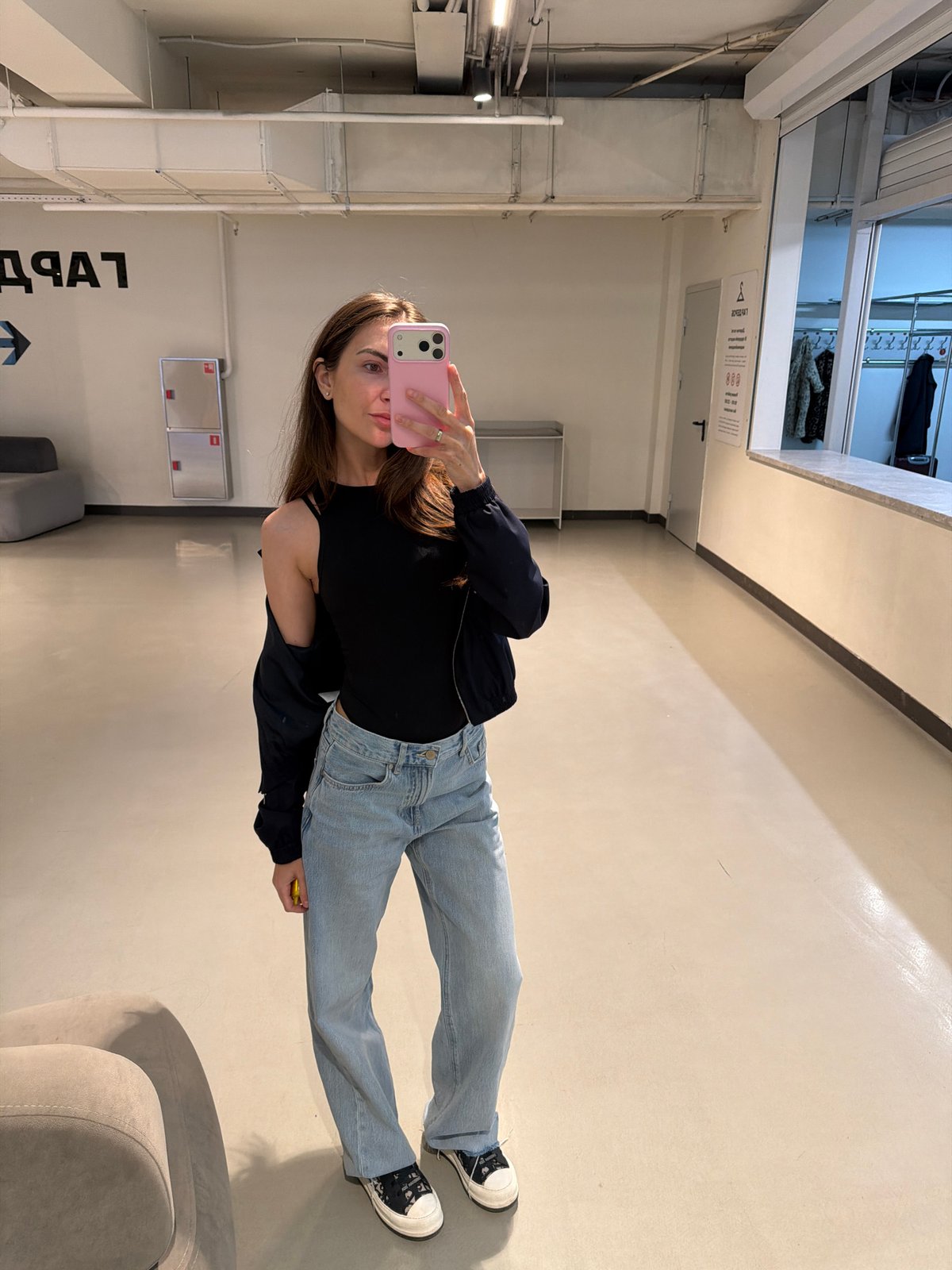 Woman takes selfie in retail space in Krasnoyarsk