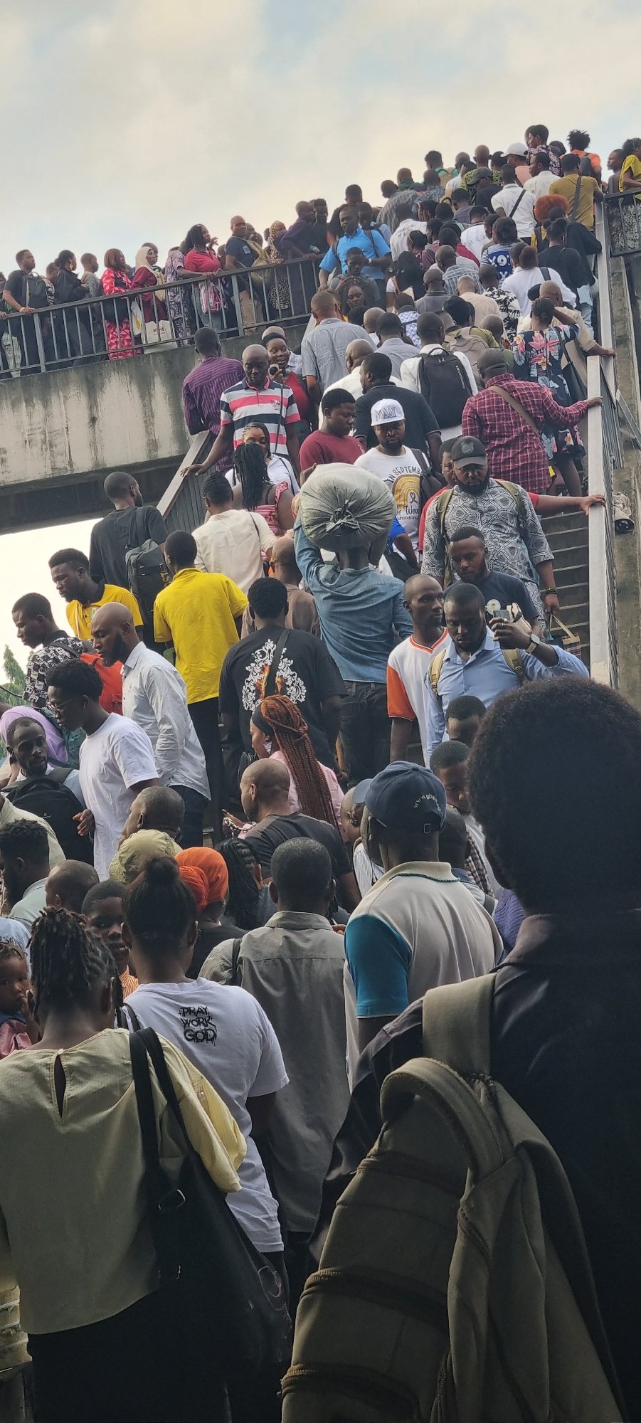 Mass crowd movement near train and overpass in Ikeja, Nigeria
