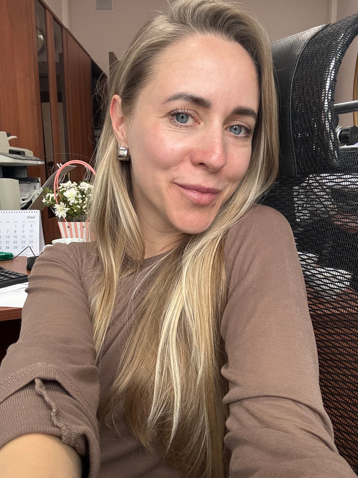 Woman observed at office desk in Chaikovsky, Russia