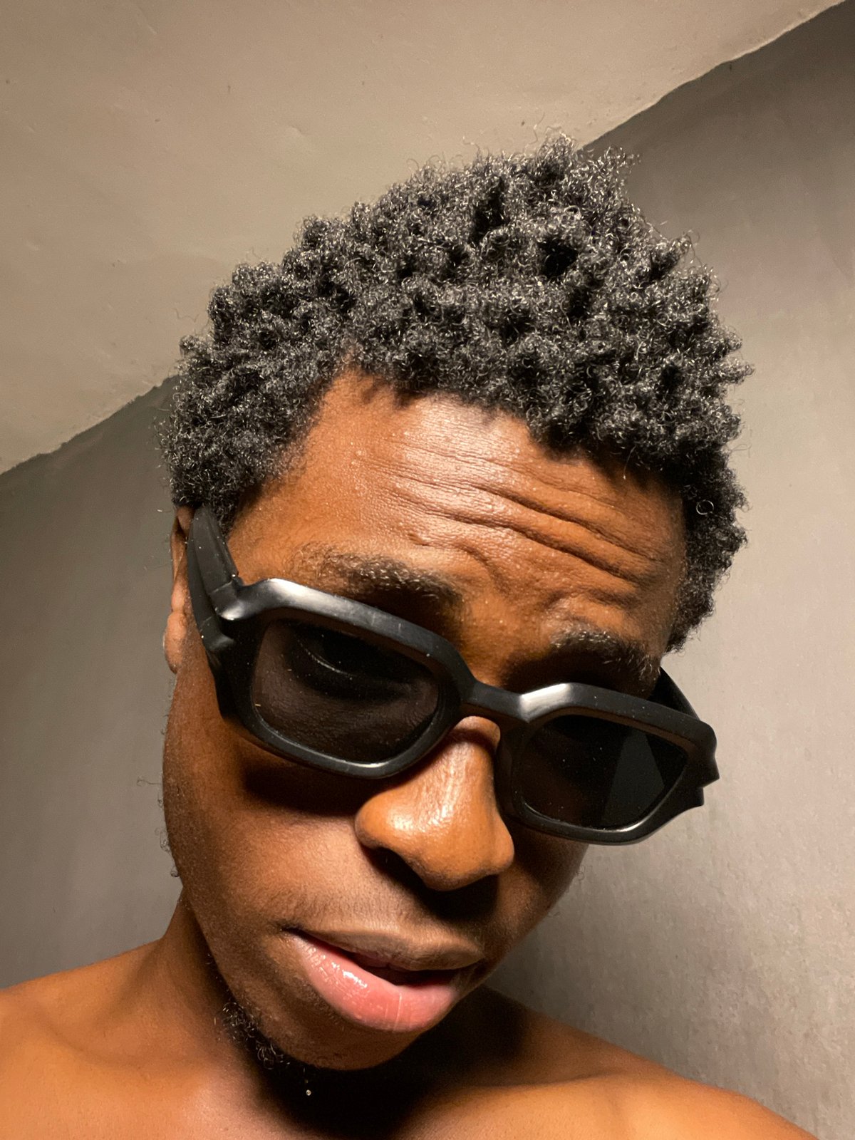 Portrait series in Nkpor, Nigeria with sunglasses and casual poses