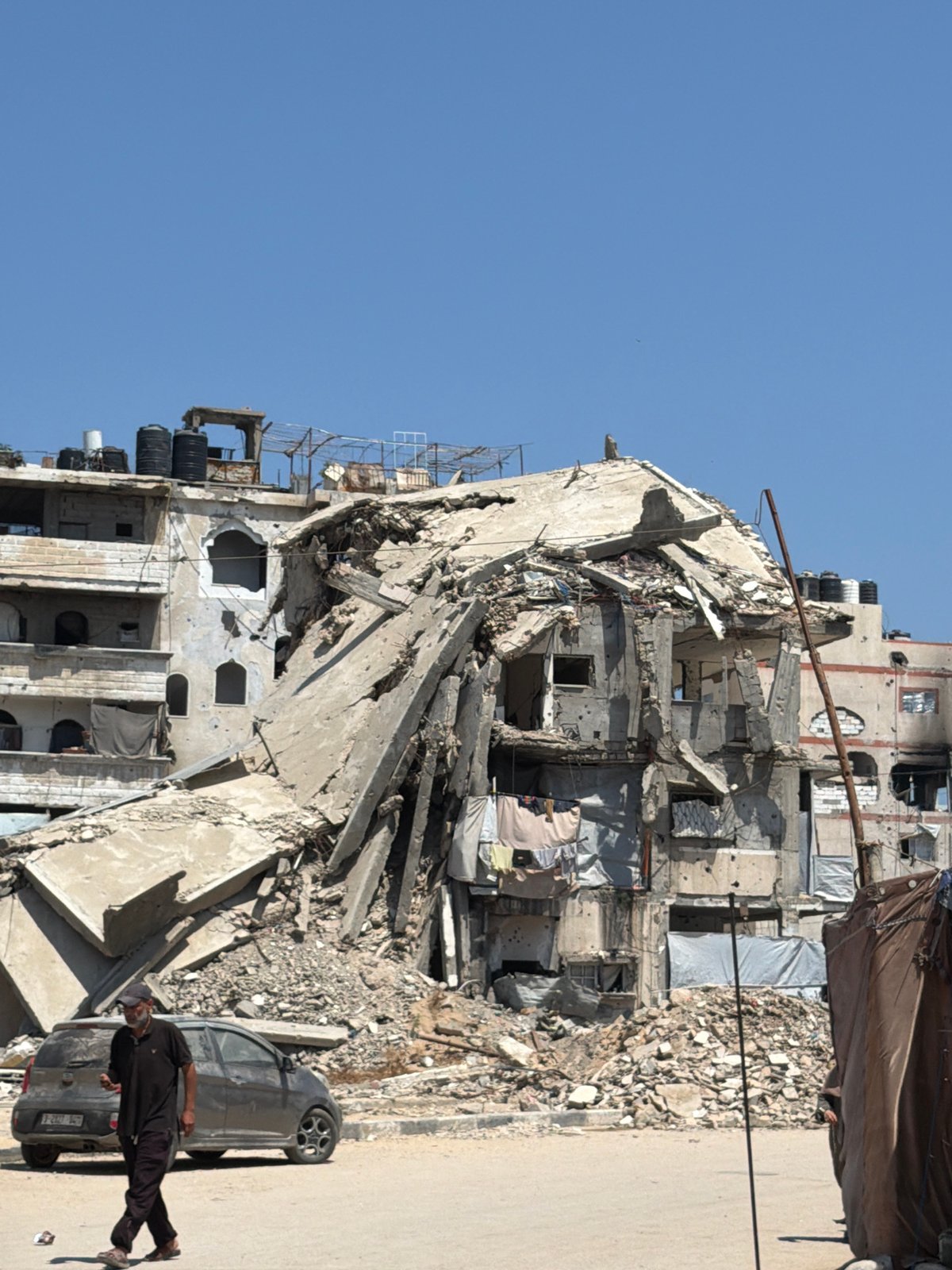 Aid workers distribute food parcels in Gaza displacement camps