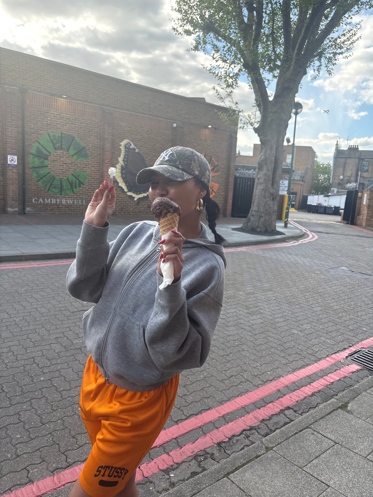 Woman enjoys ice cream on Camberwell street Sunday afternoon