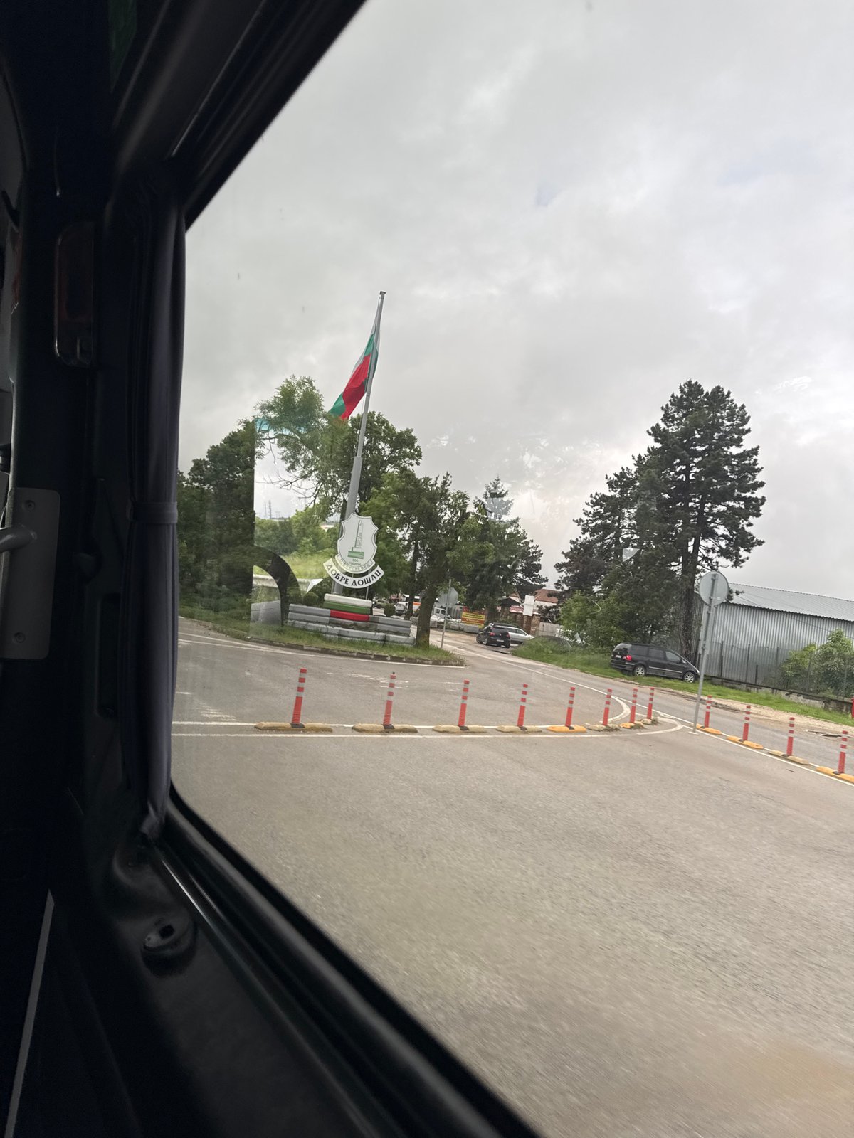 Morning drive approaches Brestovets, Bulgaria through vehicle sunroof view