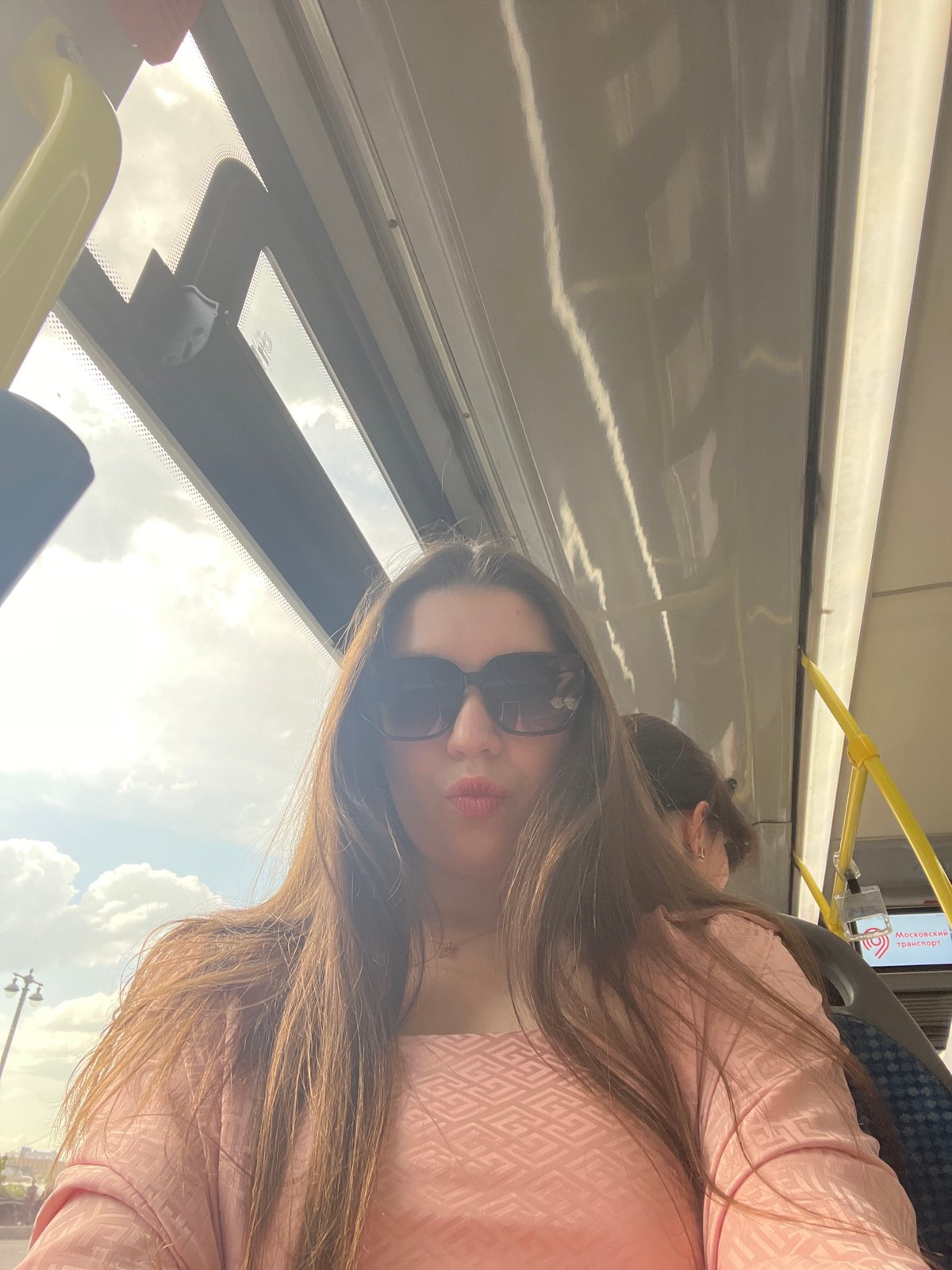 Woman rides Moscow bus as traffic flows through city streets