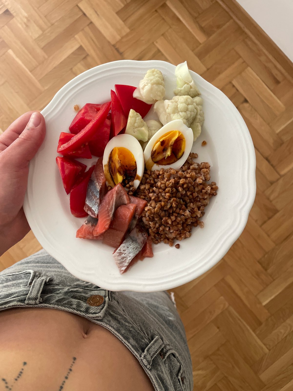 Person holds varied breakfast plate in Boreti, Montenegro