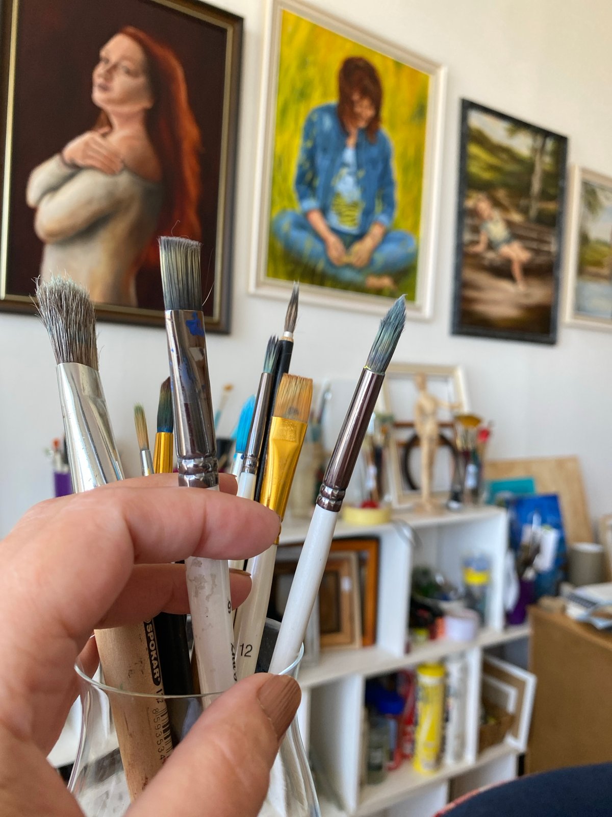 Artist's studio with paintbrushes and portraits documented in Bílina