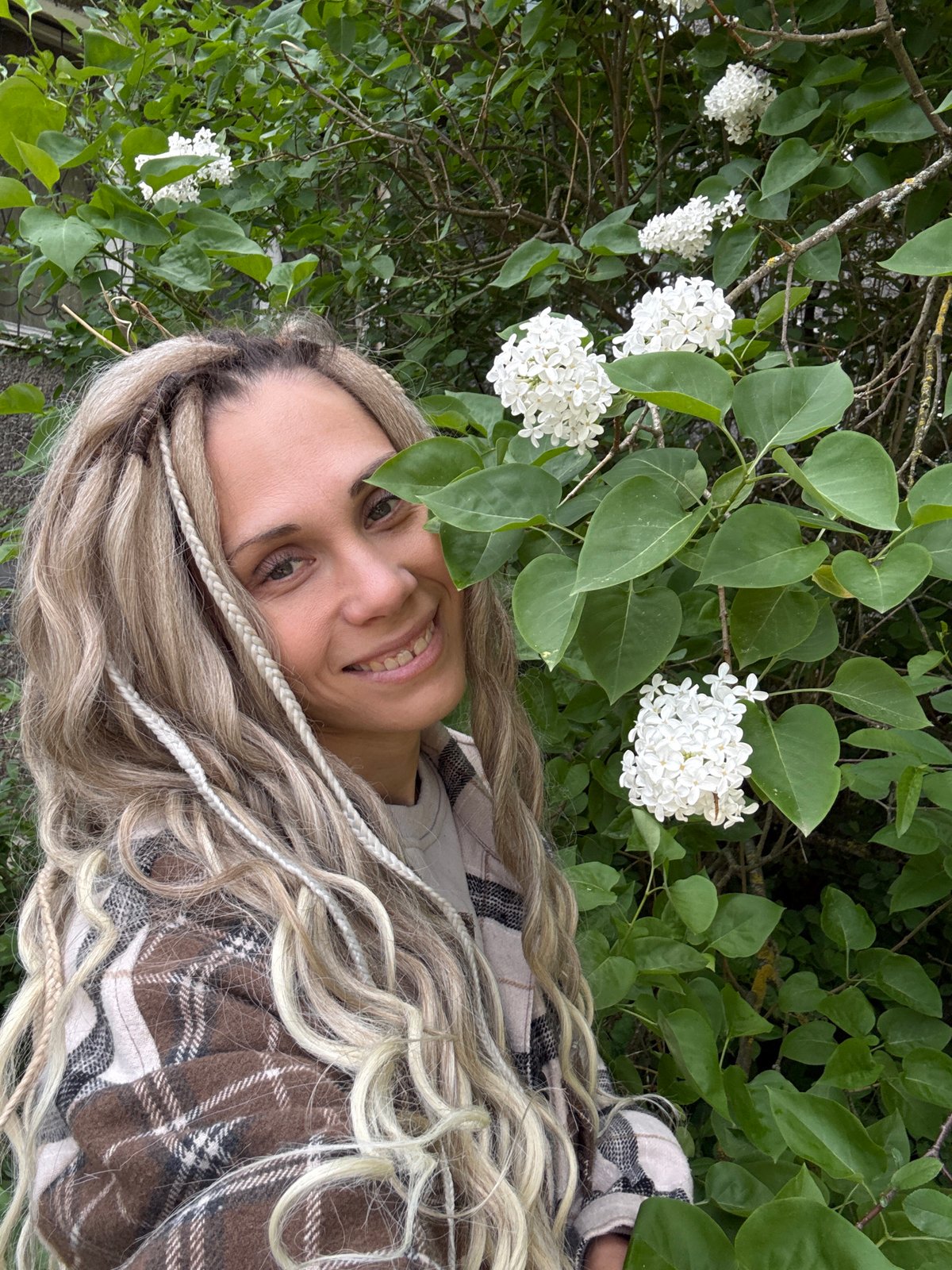 Woman poses for photos among spring flowers in Russian park