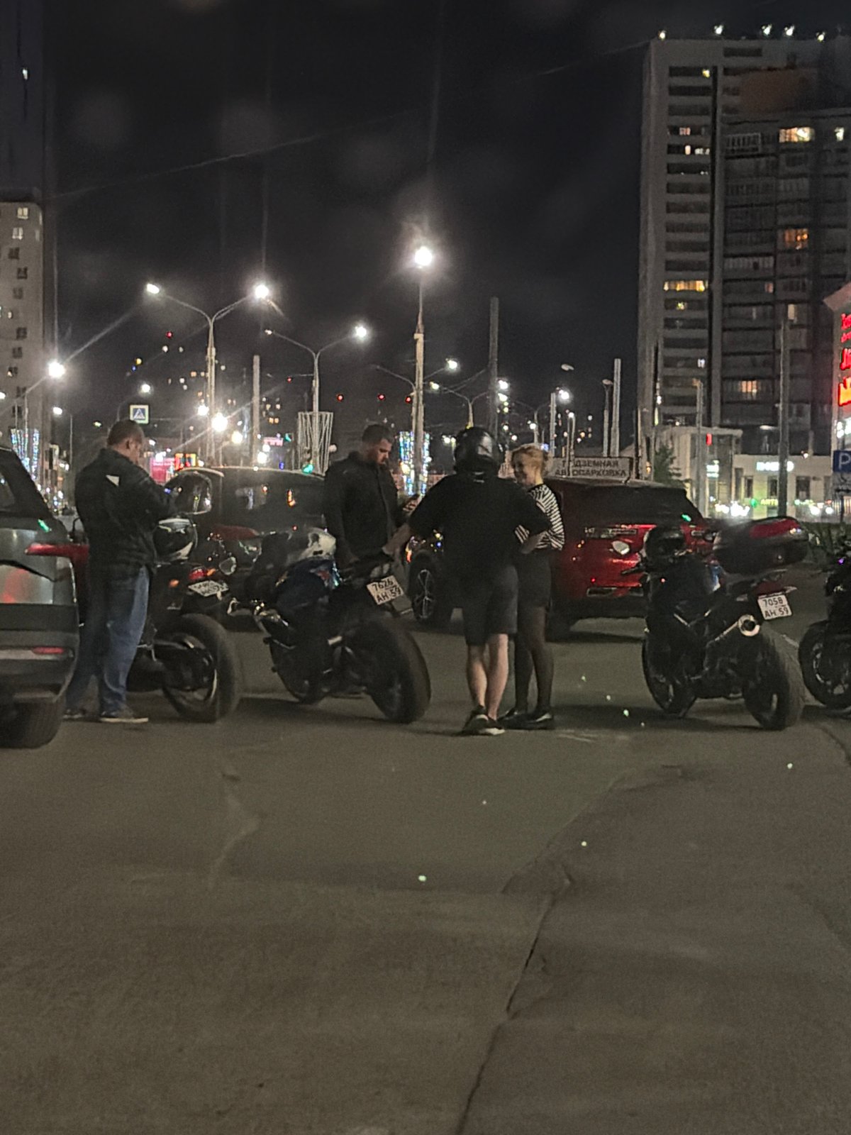 Nighttime street scenes and vehicle displays captured in Perm