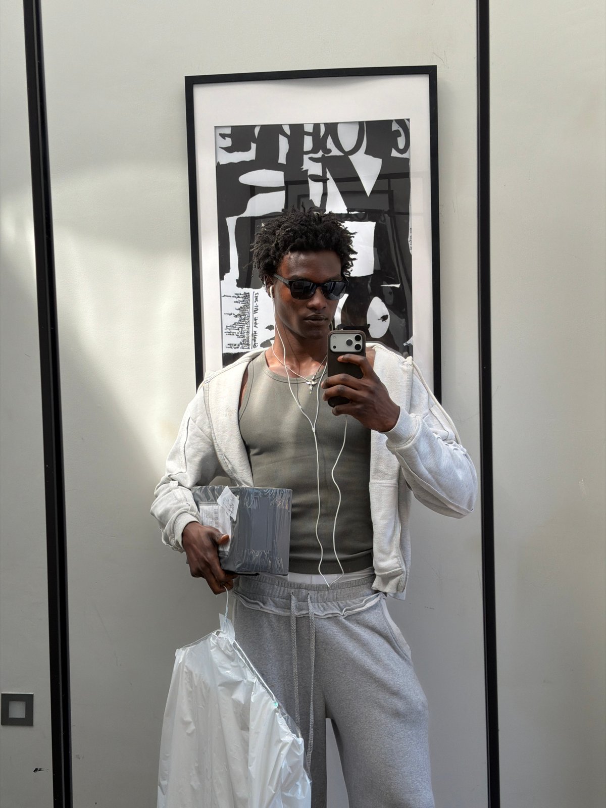 Man in grey sweatsuit photographed in mirror, London