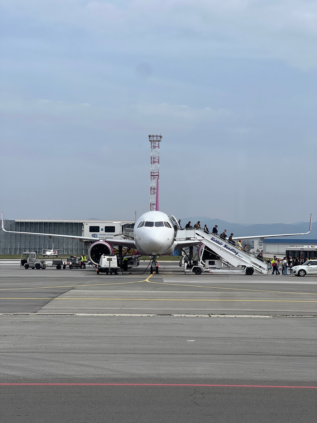 Airbus A320 parked at Sofia Airport with ground support