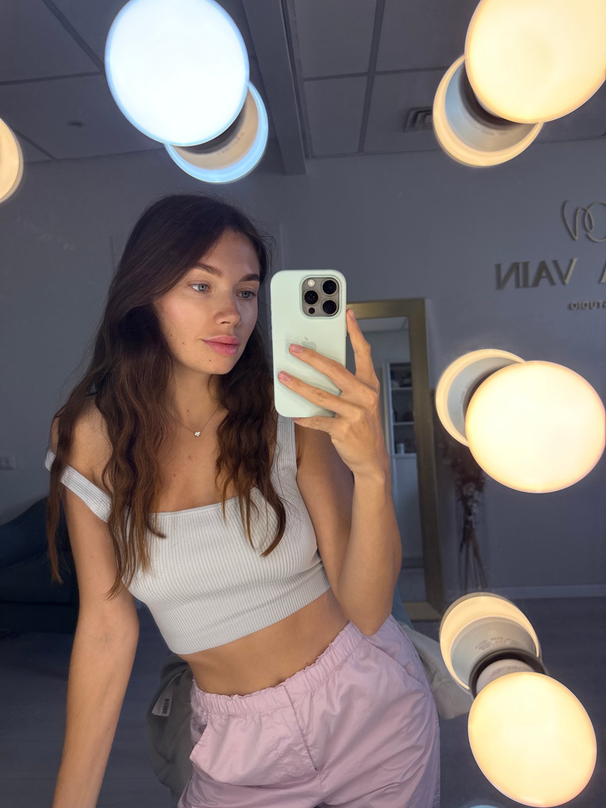 Woman takes selfie at vanity mirror in Ramat Gan
